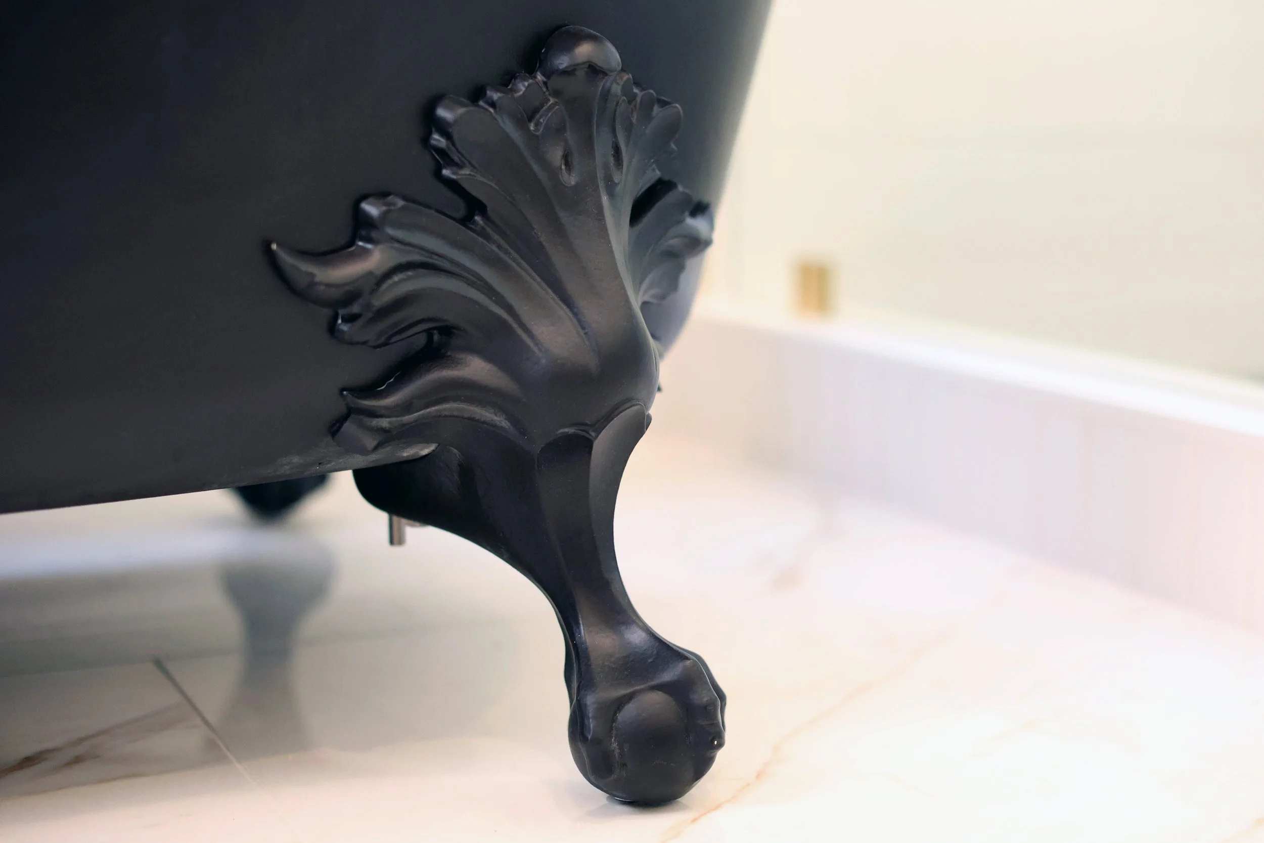 Decorative black clawfoot tub leg in a historic Victorian bathroom in Bethlehem NH.