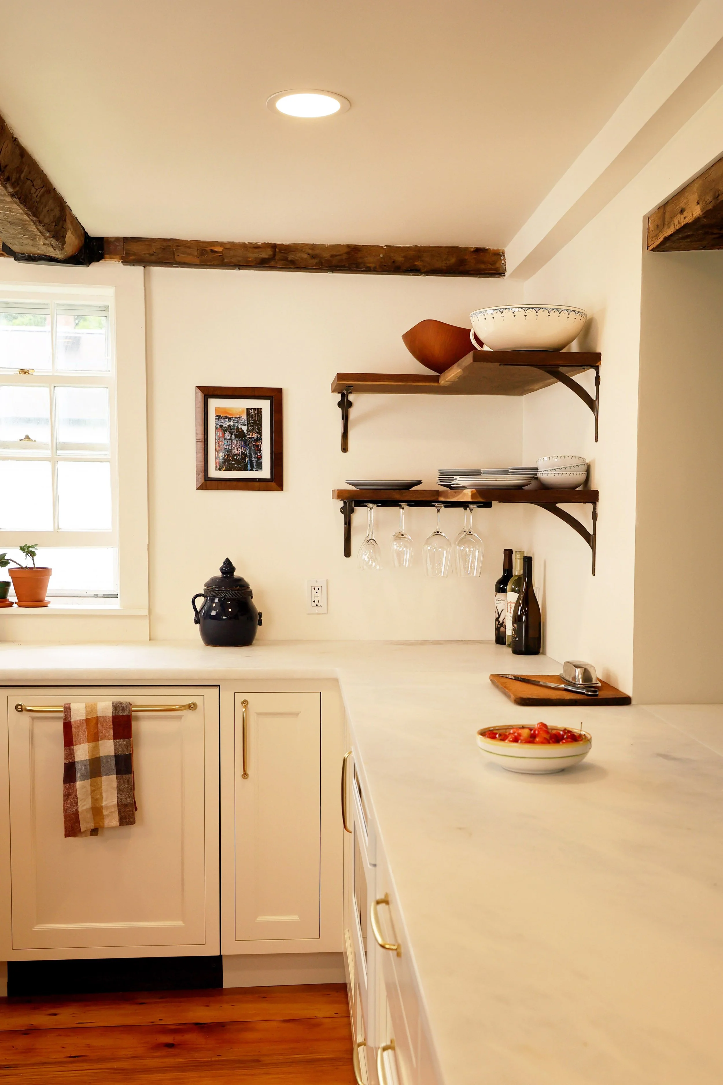 Handcrafted walnut shelves by Andrew Pearce featured in a high-end Vermont kitchen renovation.