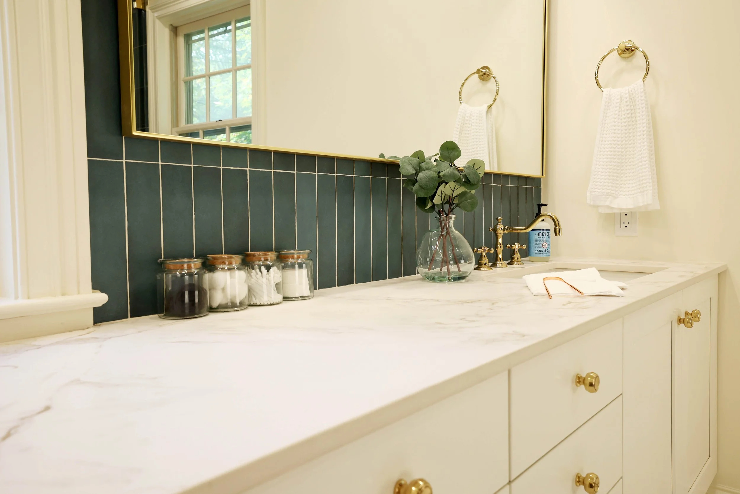 Dekton by cosentino bathroom countertop with brass faucet and blue tile backsplash in Hanover NH