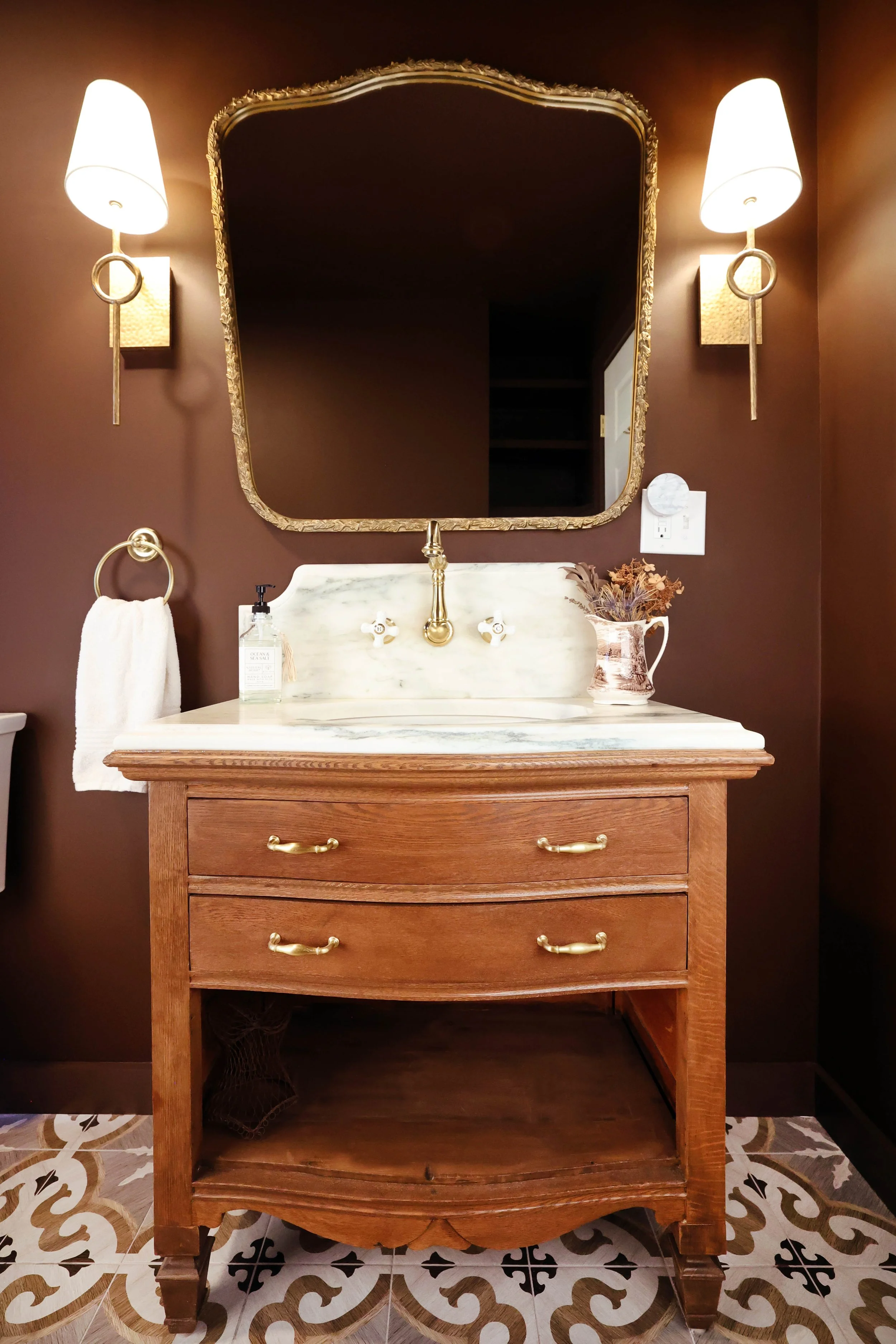 Full antique dresser to vanity conversion with marble countertop and brass fixtures.