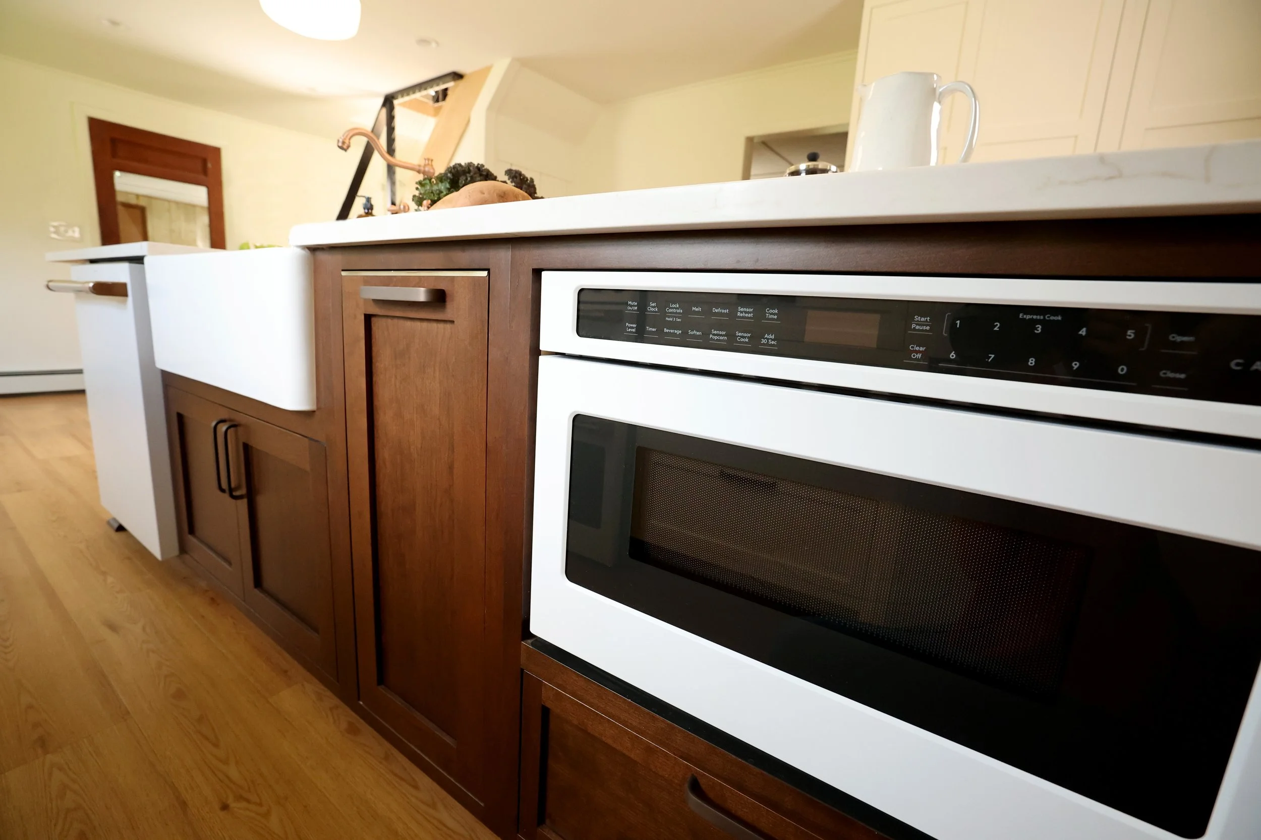 Café GE drawer microwave integrated into walnut island cabinetry in a historic Bethlehem NH farmhouse kitchen renovation.