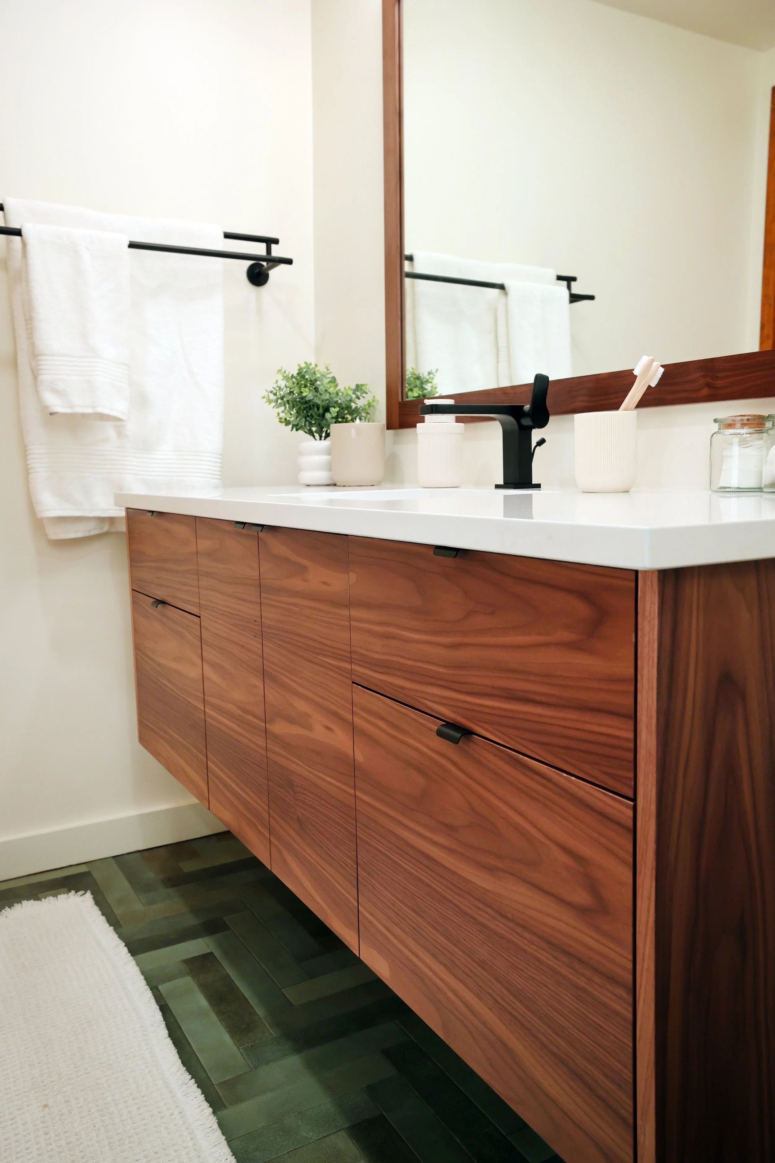 Wide walnut vanity by Teodor Vanities in a Hanover NH midcentury bathroom renovation.