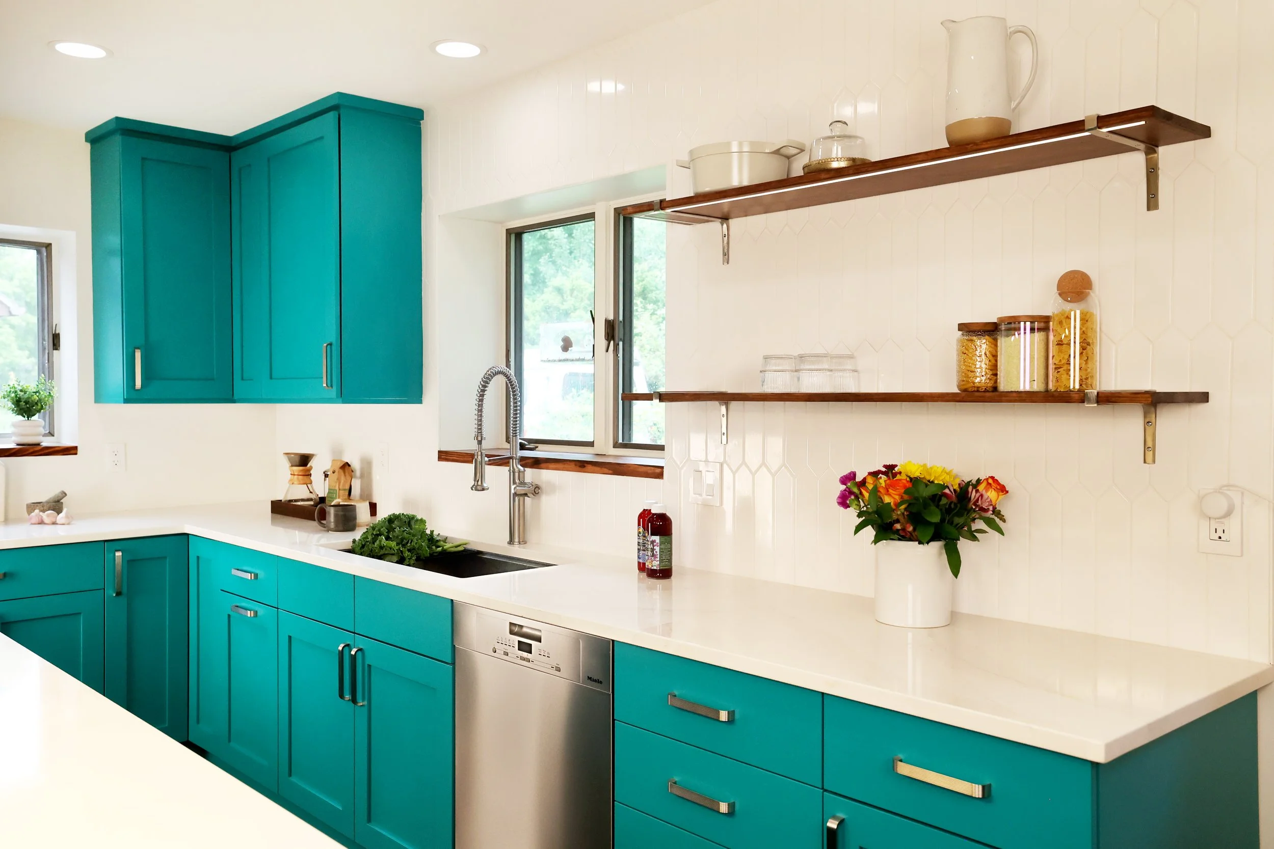 Kitchen sink wall with teal cabinetry painted Benjamin Moore Gulf Shores in a White River Junction Vermont kitchen.