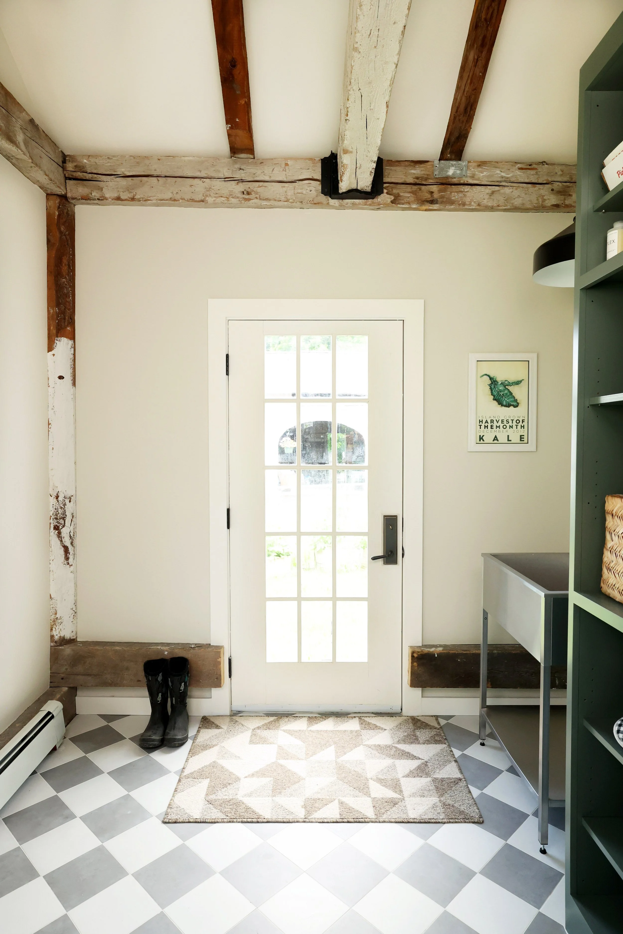 Farmhouse mudroom entry with custom storage and historic beams in a Thetford Vermont home.