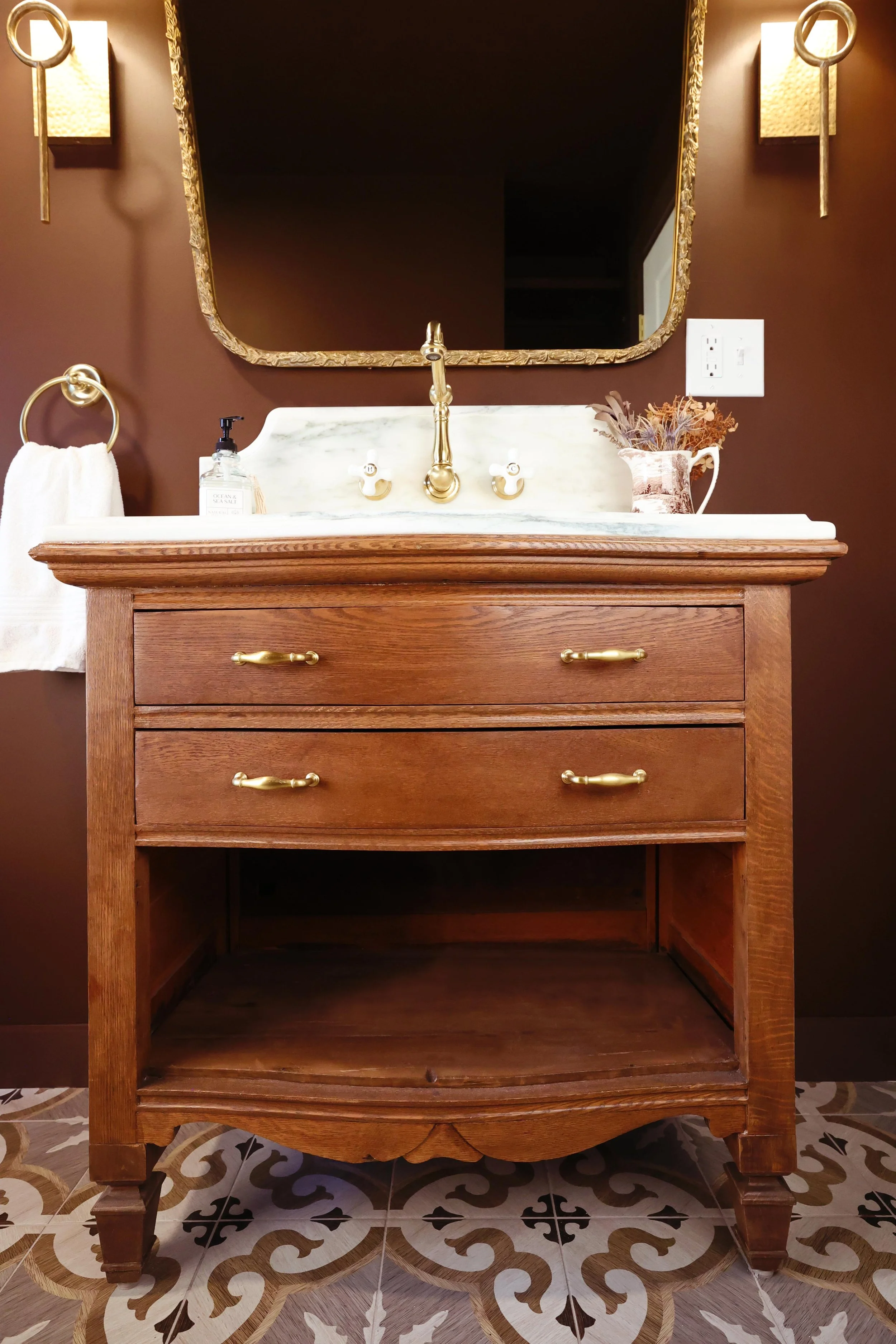 Full antique dresser to vanity conversion with marble countertop and brass fixtures.