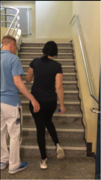 Taking supported steps up a staircase