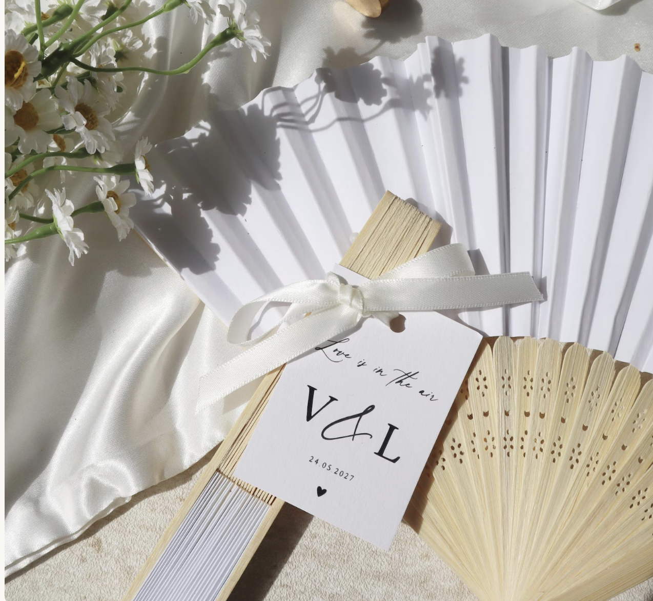 Personalised handheld wedding fans for guests to keep cool during a hot summer wedding.