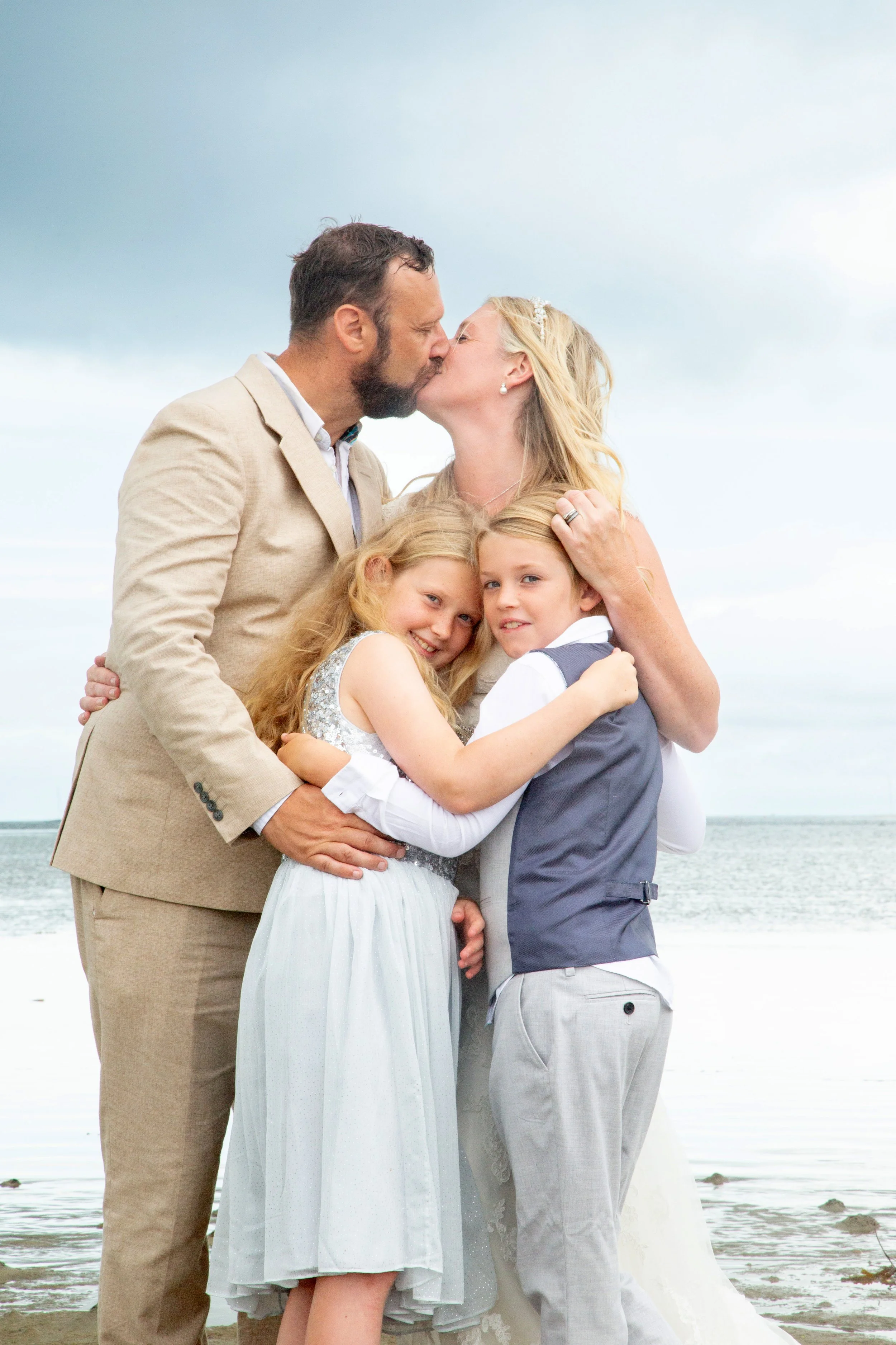 Emotional family hug during wedding day, natural candid moment showing connection and joy, documentary wedding photography