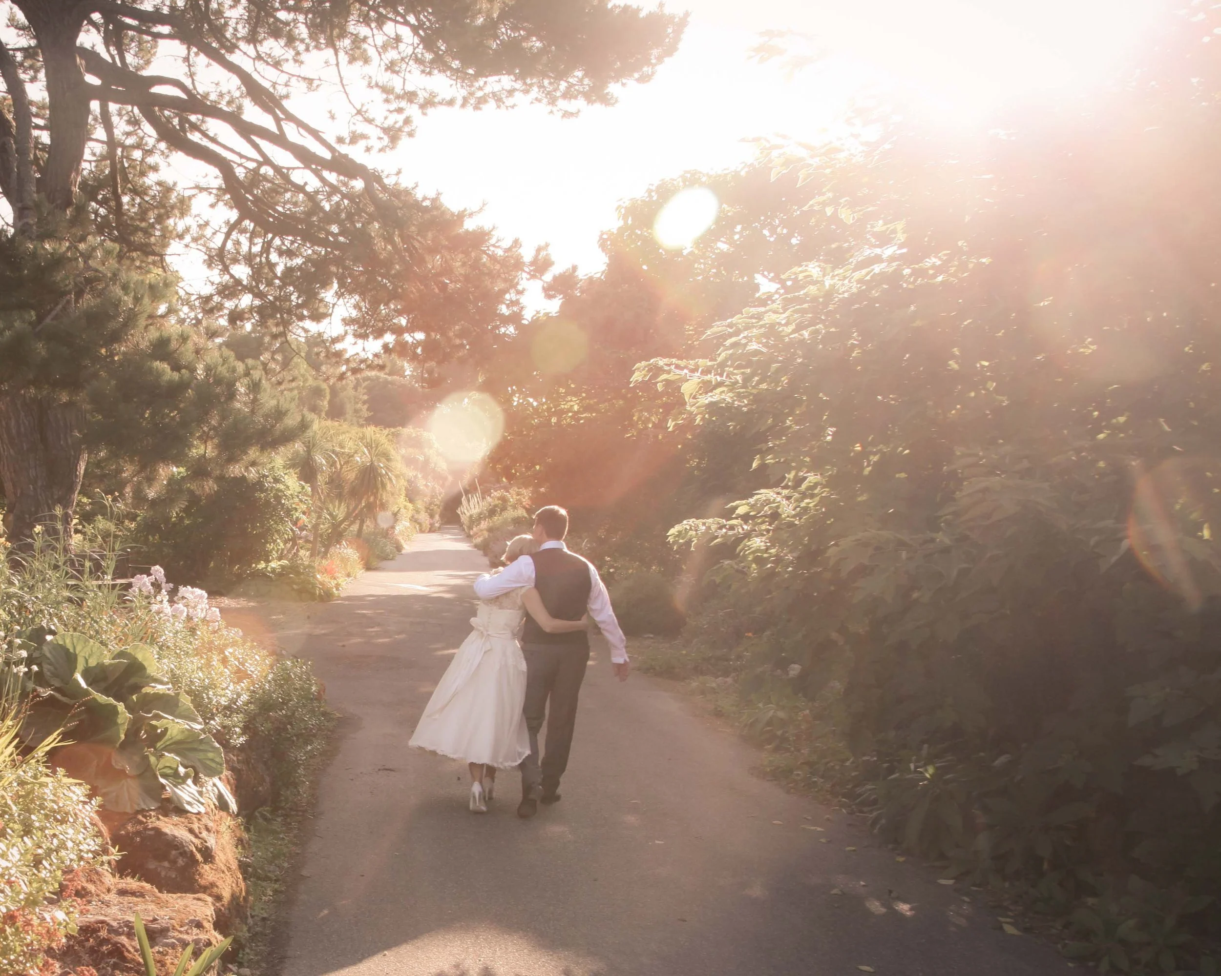 Bride and groom walking together in golden evening light, romantic and natural wedding moment, Isle of Wight wedding photography