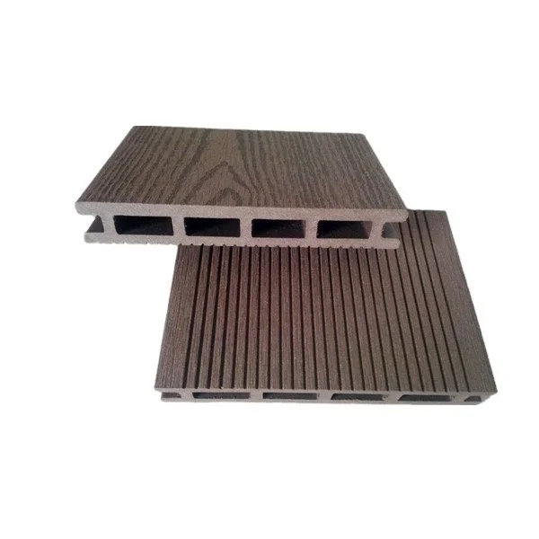 Two brown composite decking boards with grooved surfaces, one showing the underside with hollow channels.