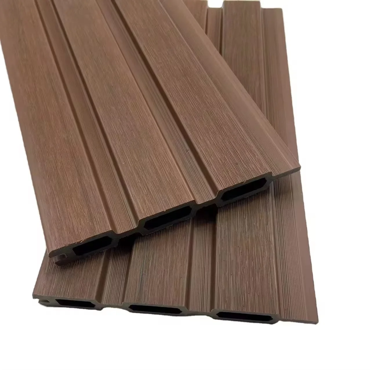 Two brown composite decking planks with textured wood grain pattern stacked on each other.