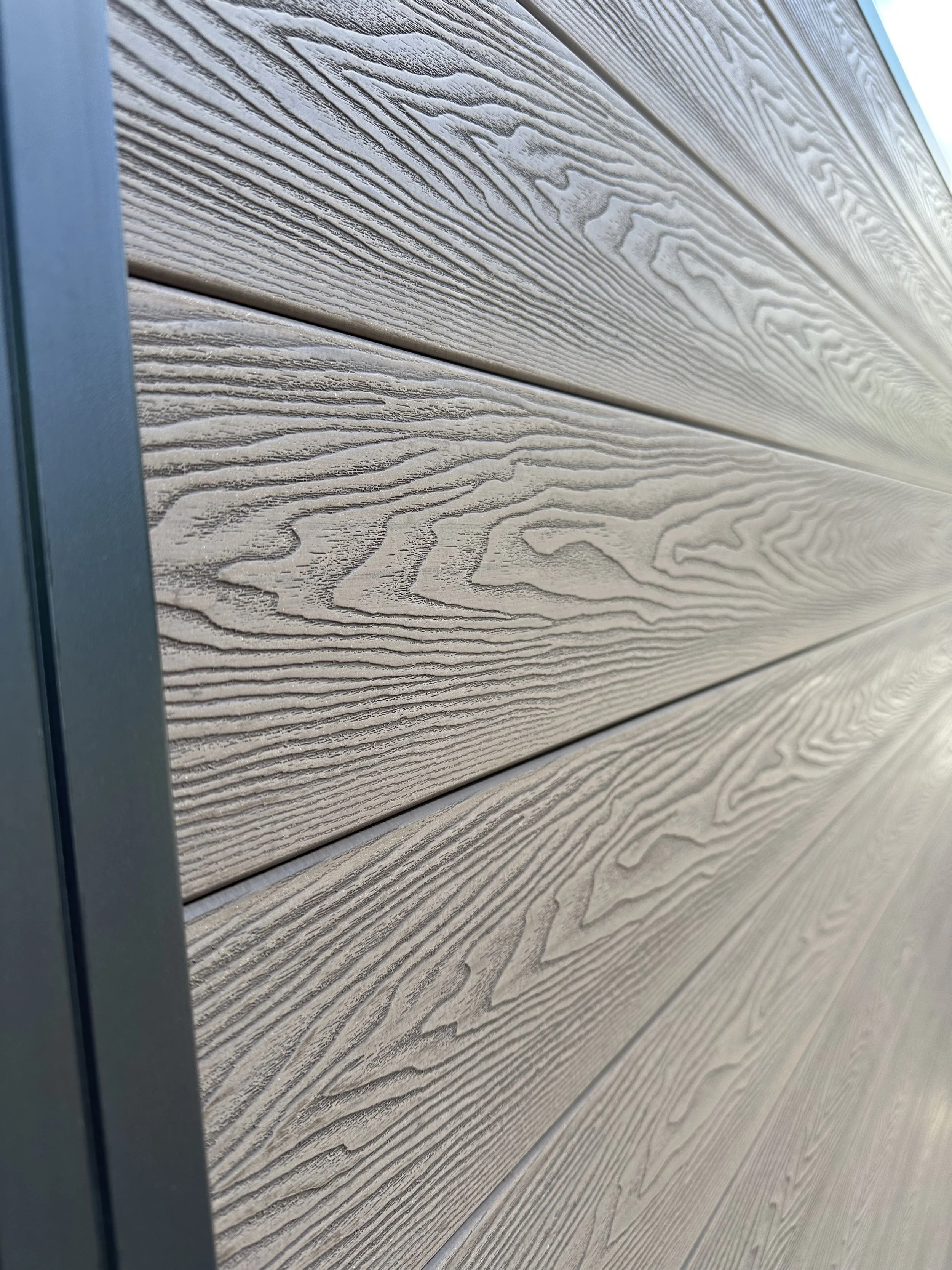 Close-up of horizontal wooden siding with a textured grain pattern.