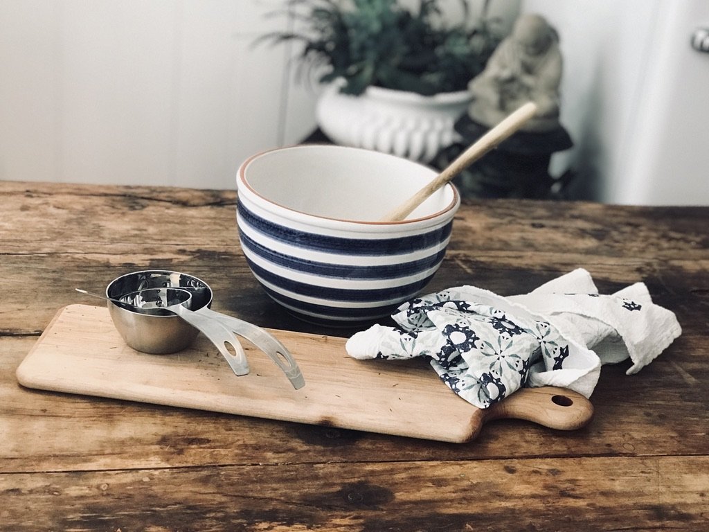 Wooden table with mixing bowl and utensils
