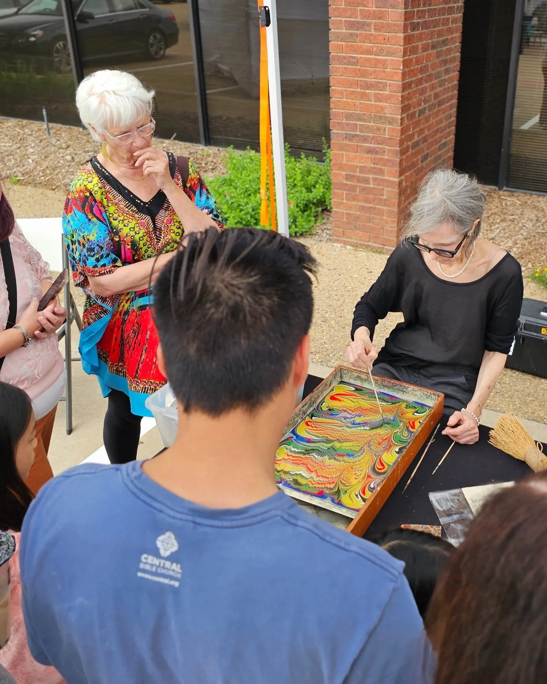 Miss marble demostrating how to marble paper