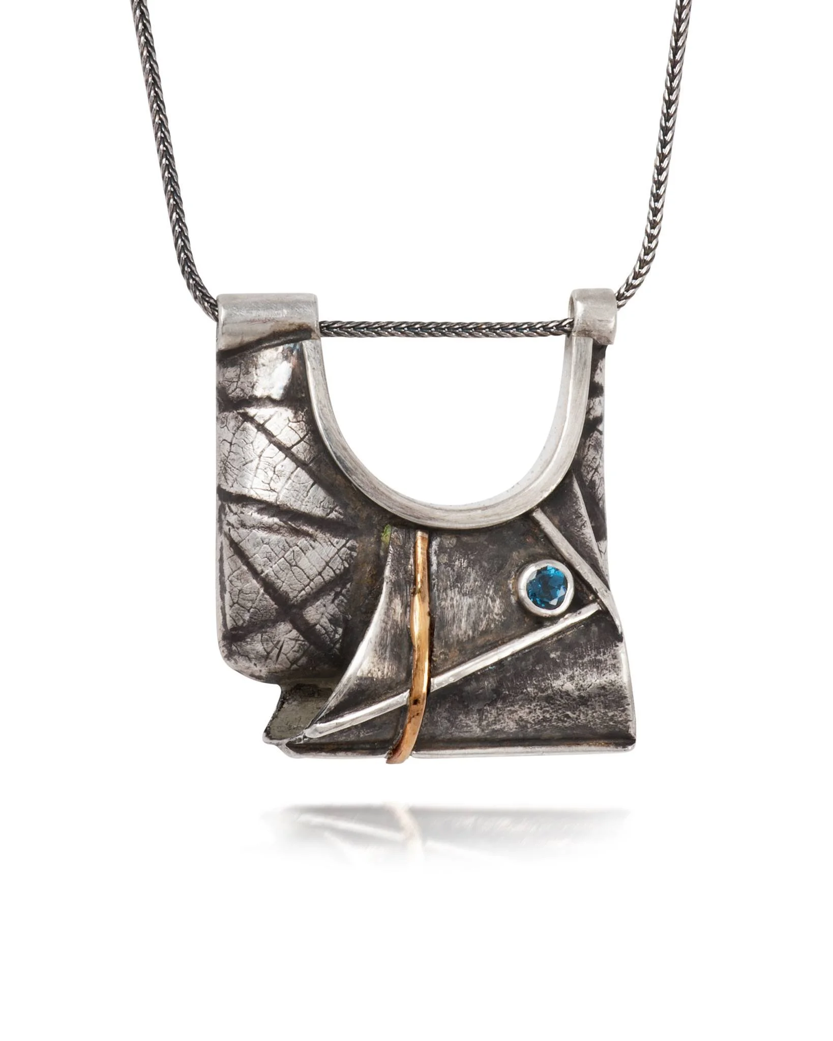 Modern abstract silver necklace with geometric design, featuring a blue gemstone and a small gold element, on a silver chain.