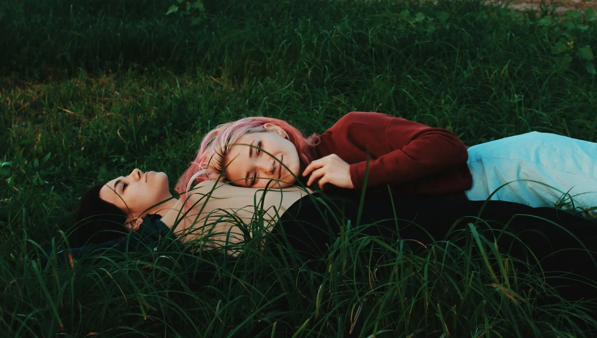 Queeres, lesbisches Paar kuschelnd auf einer Wise liegend | queersensible Paarberatung | Paartherapie | systemische Beratung | psychologische Beratung | Paarcoaching | Annu Jona Winkler | Berlin und online