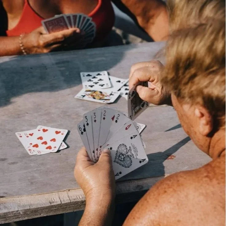 Friends playing a traditional Italian card game, celebrating fun, connection, and local culture.