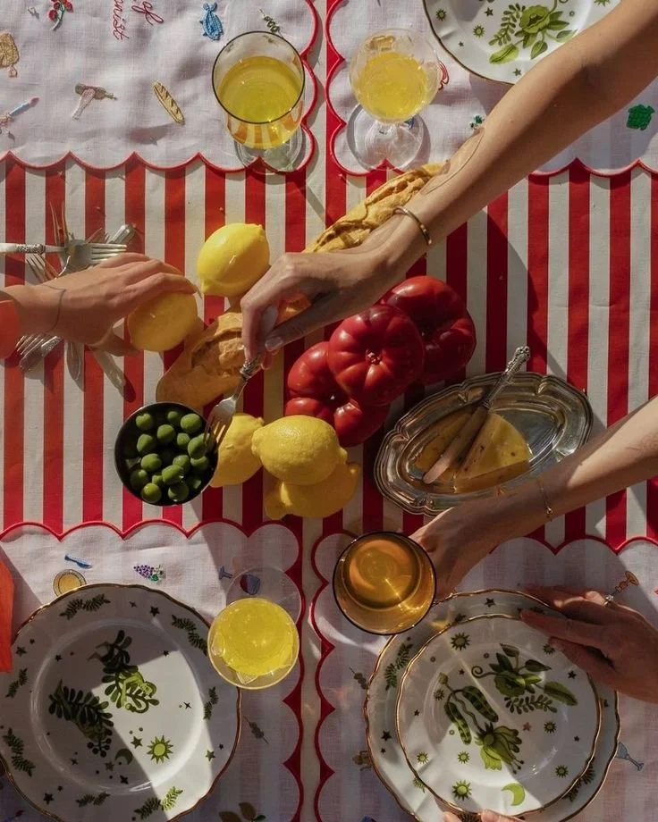 A sunlit Italian table scene celebrating simple food, shared moments, and Mediterranean charm.