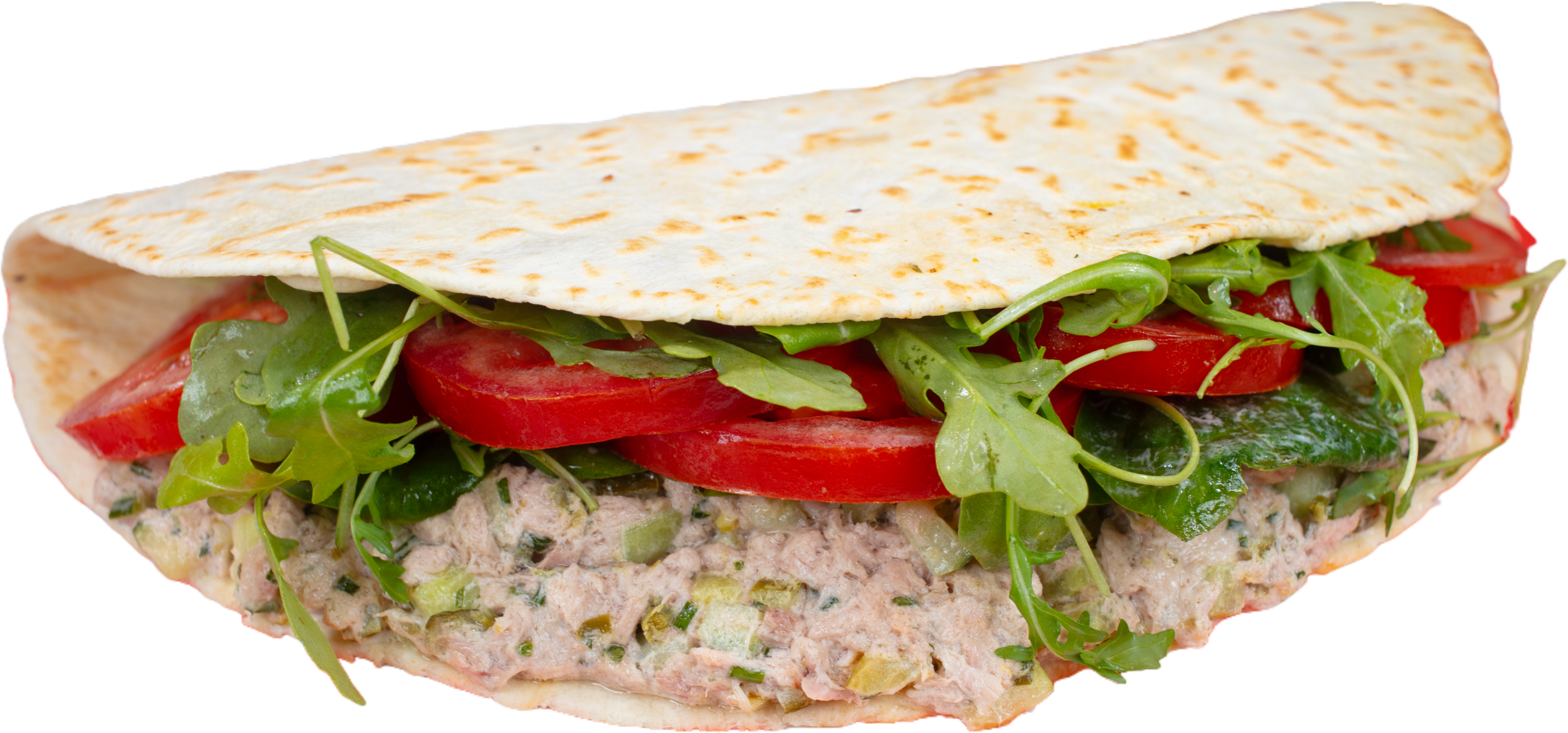 A pita bread filled with tuna salad, sliced tomatoes, leafy greens, and arugula, showing layered ingredients.