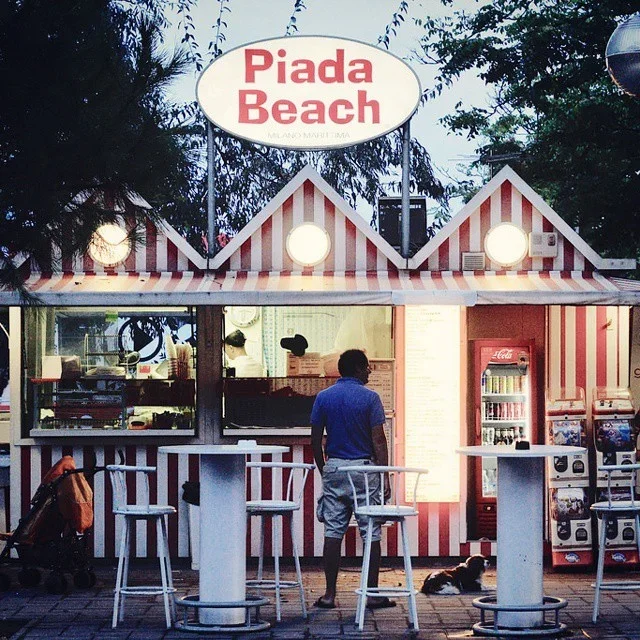 a piada bar with a italian person who is waiting to order
