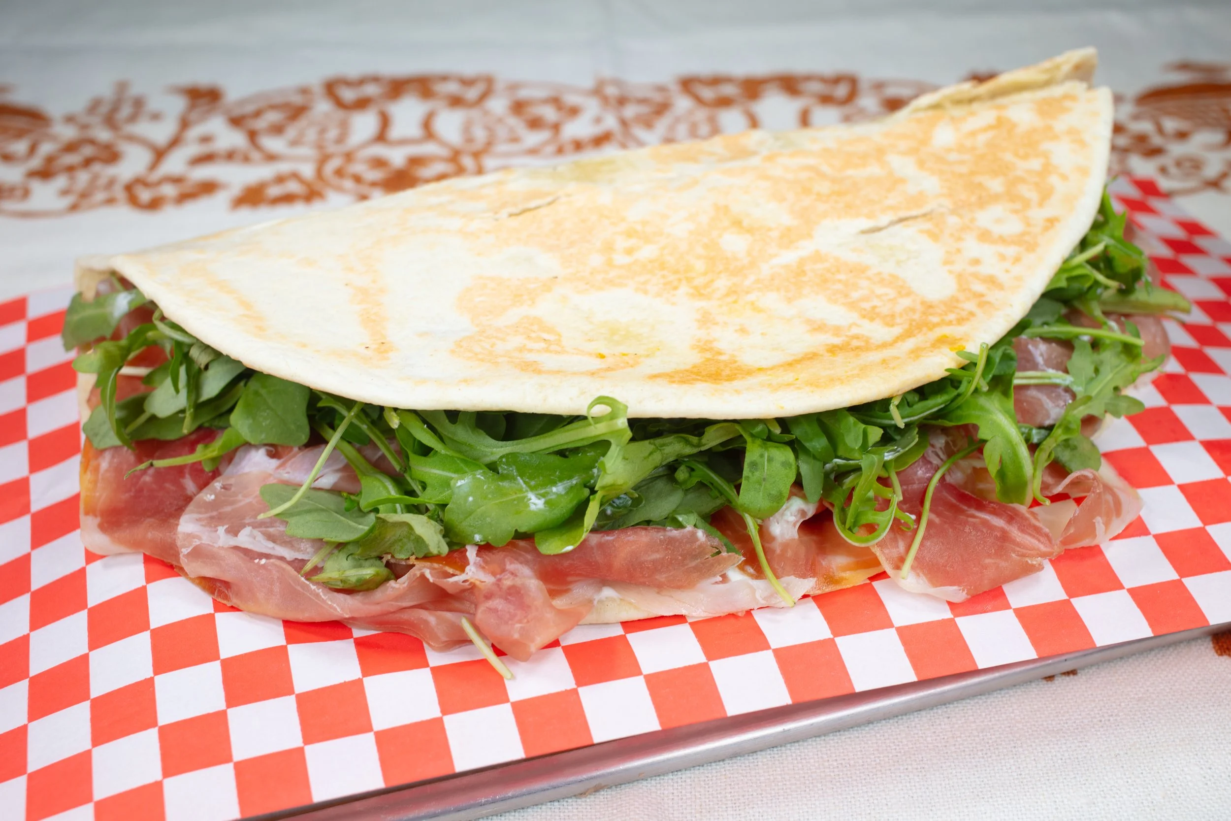 Piadina filled with prosciutto di Parma, Squacquerone Cheese, Arugula