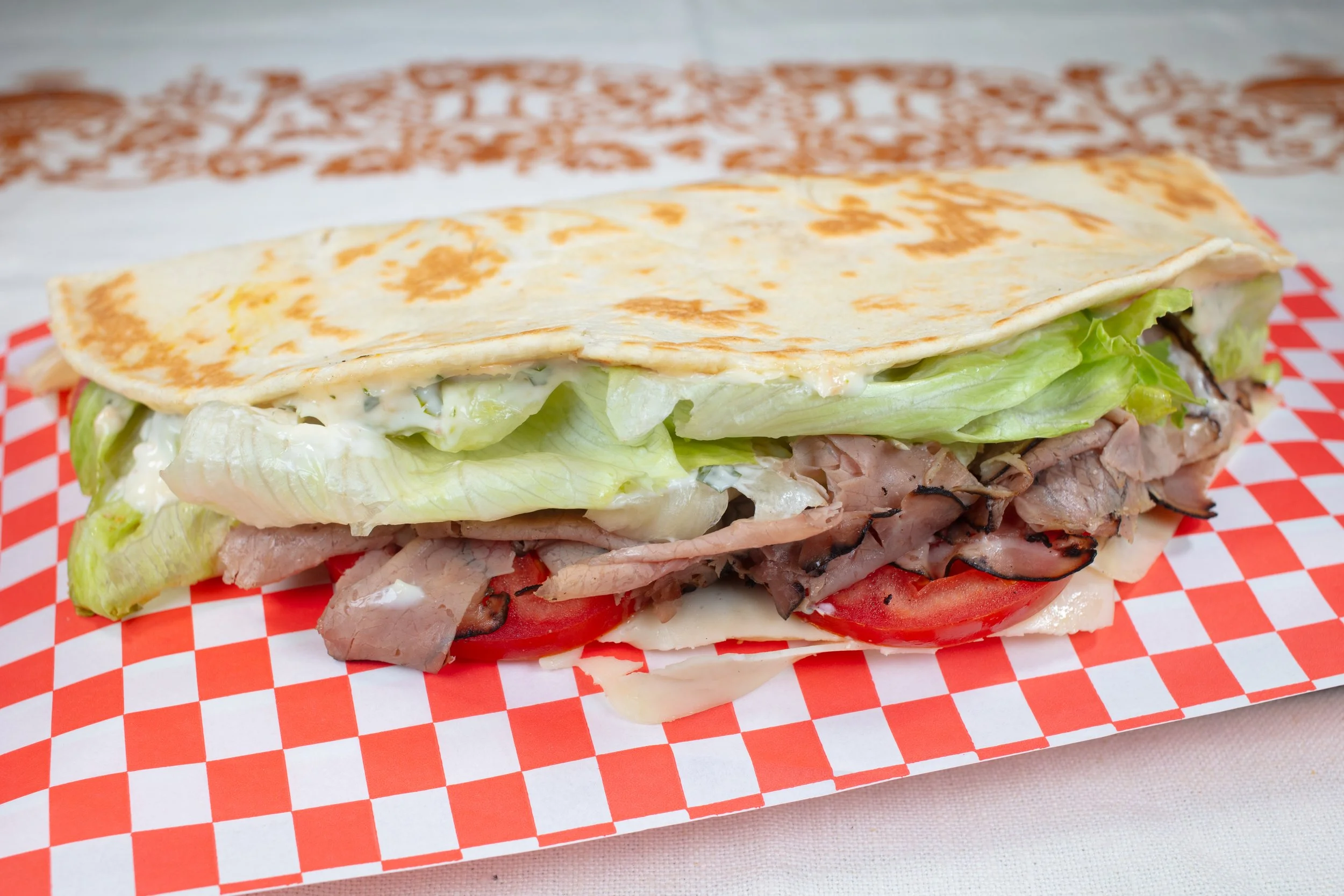Piadina filled with Roast Beef, Lettuce, Tomato, Caramelized Onion, Mozzarella Cheese, Horseradish Mayonnaise