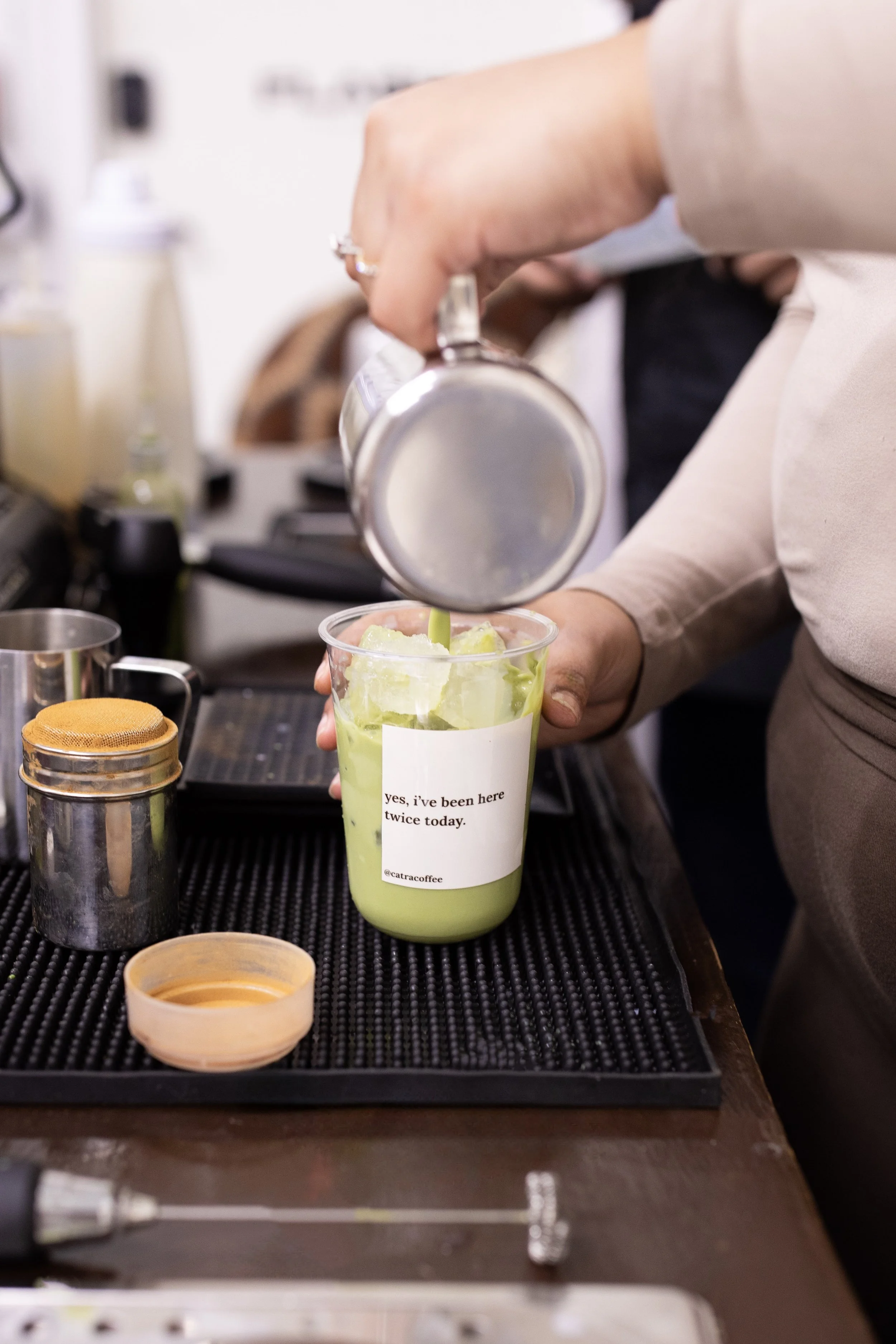 A person pouring a beverage into a plastic cup with a label that says, 'yes, I've been here twice today.' Coffee being catered in Port Saint Lucie