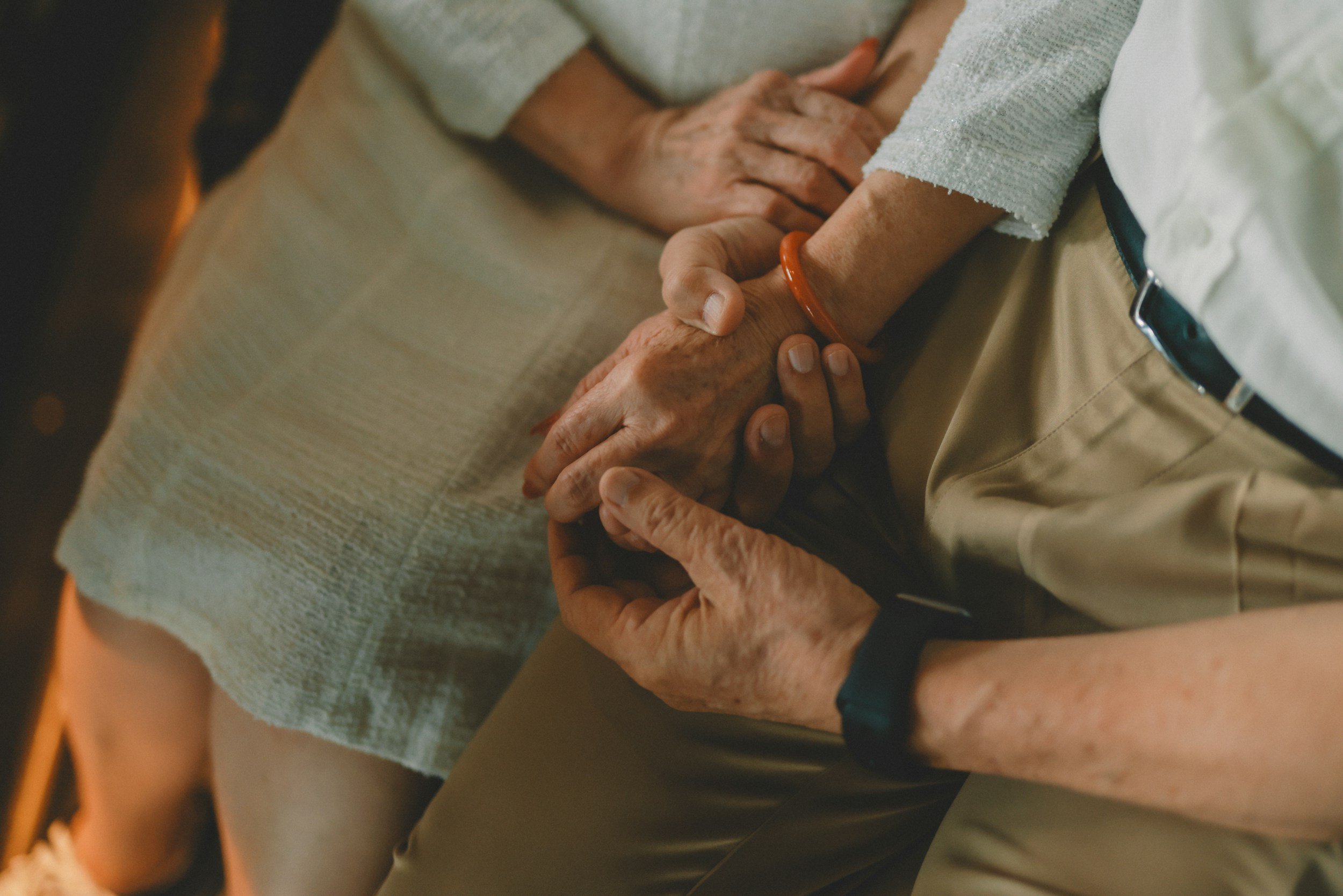 older couples embracing when faced with challenges with elder parents
