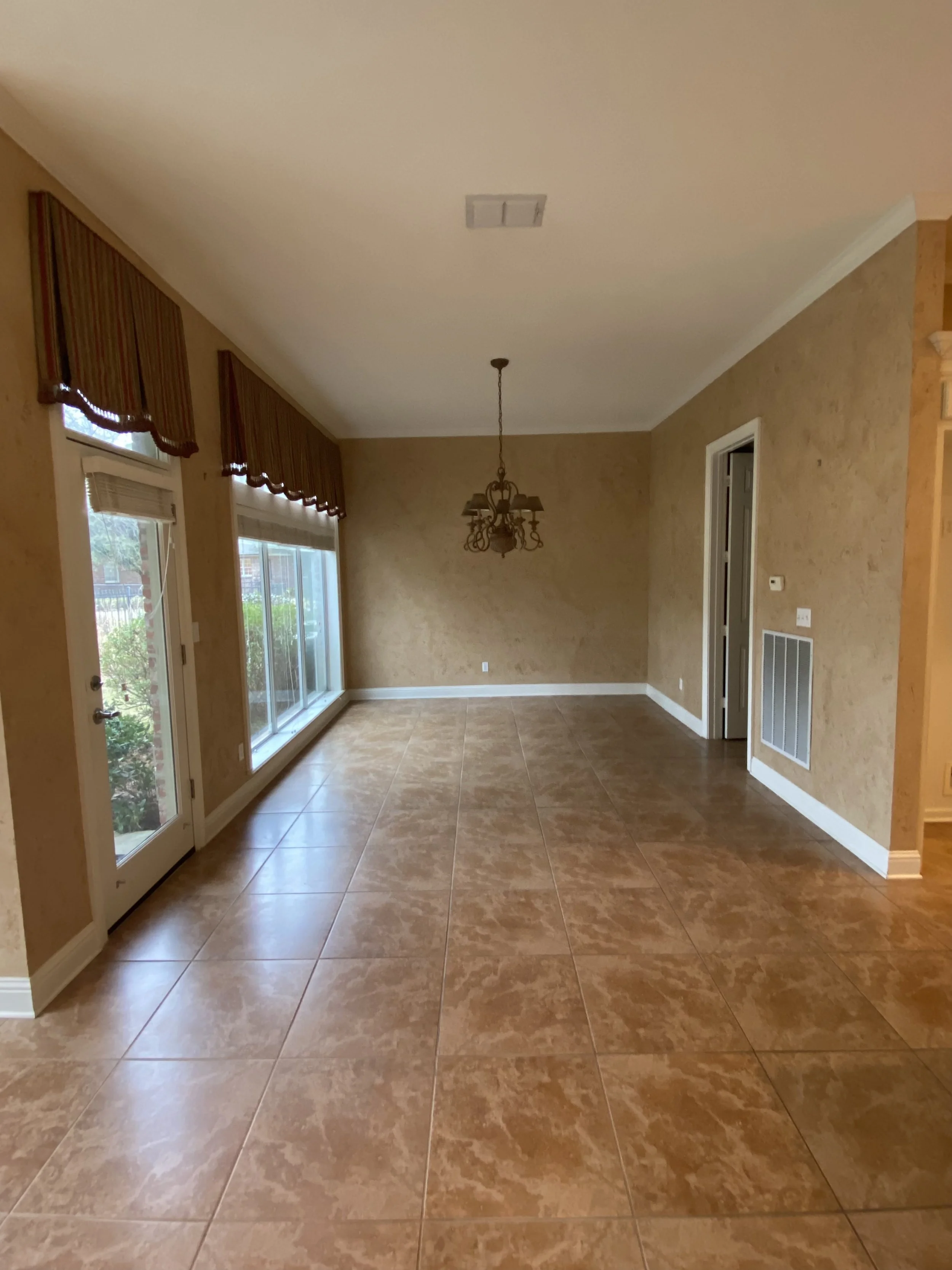 Before: Dark floors, dark walls, and dark window coverings.