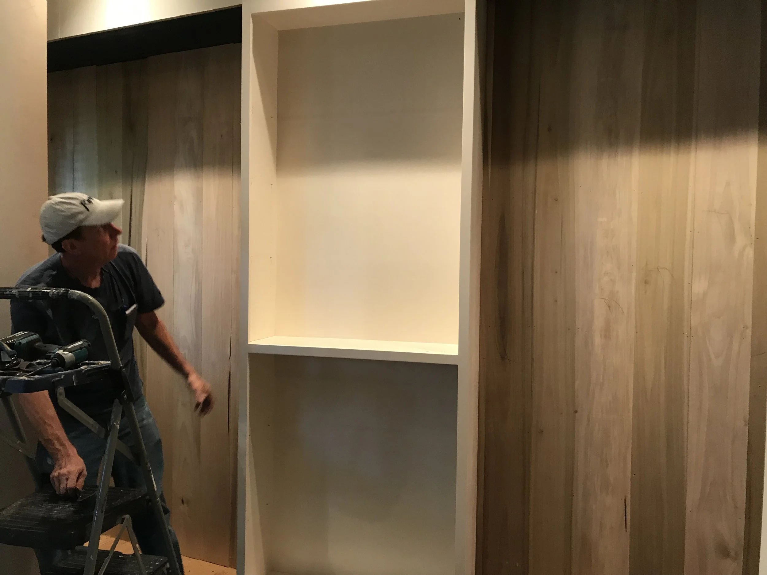 During: Den's removal of built-in bookshelves.