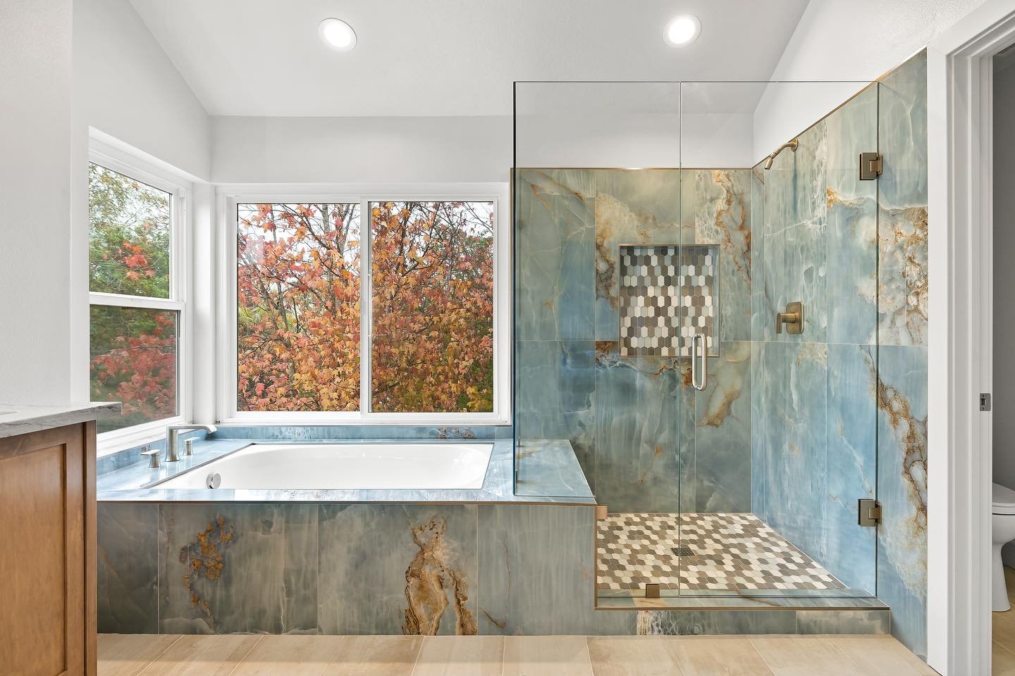 A luxury bath retreat remodel with stunning stone and a view ✨