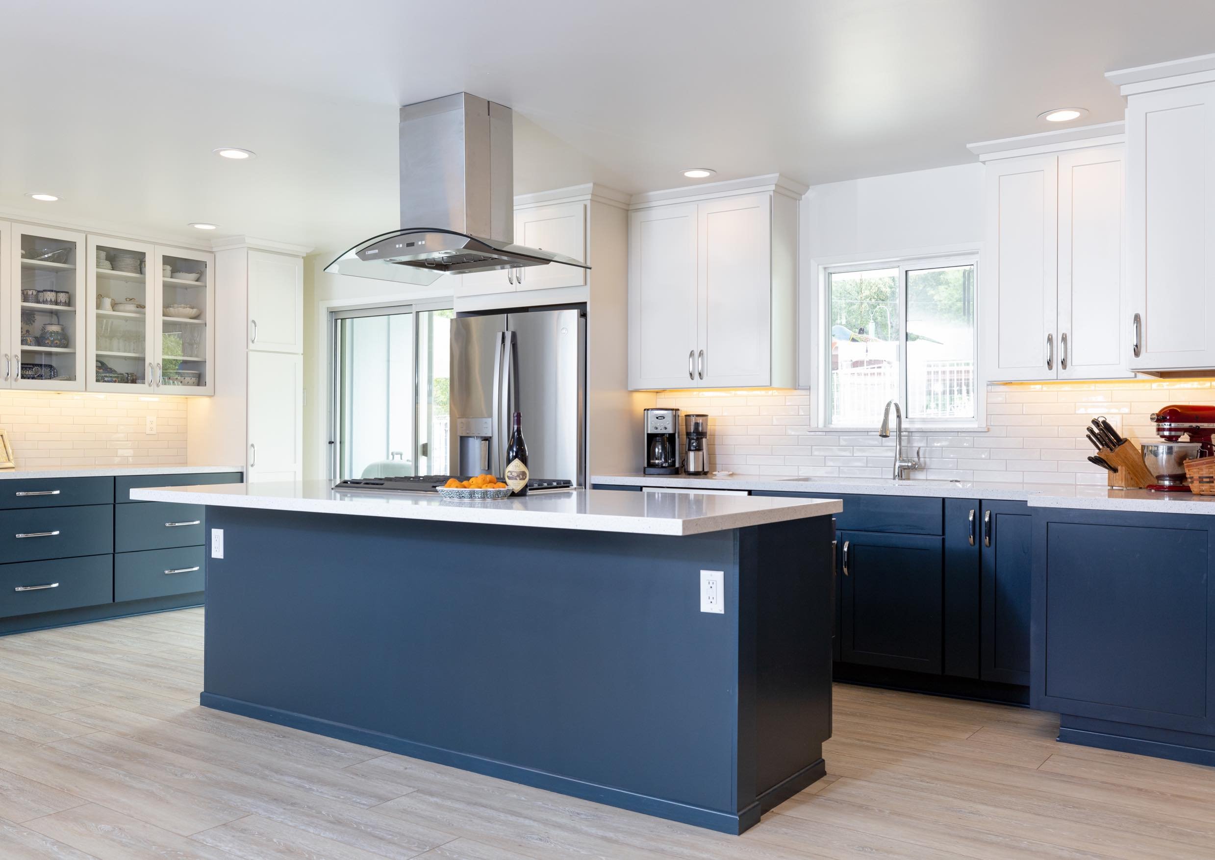 Bright, modern kitchen renovation with bold navy cabinetry, quartz surfaces, and a sleek open-concept layou ✨