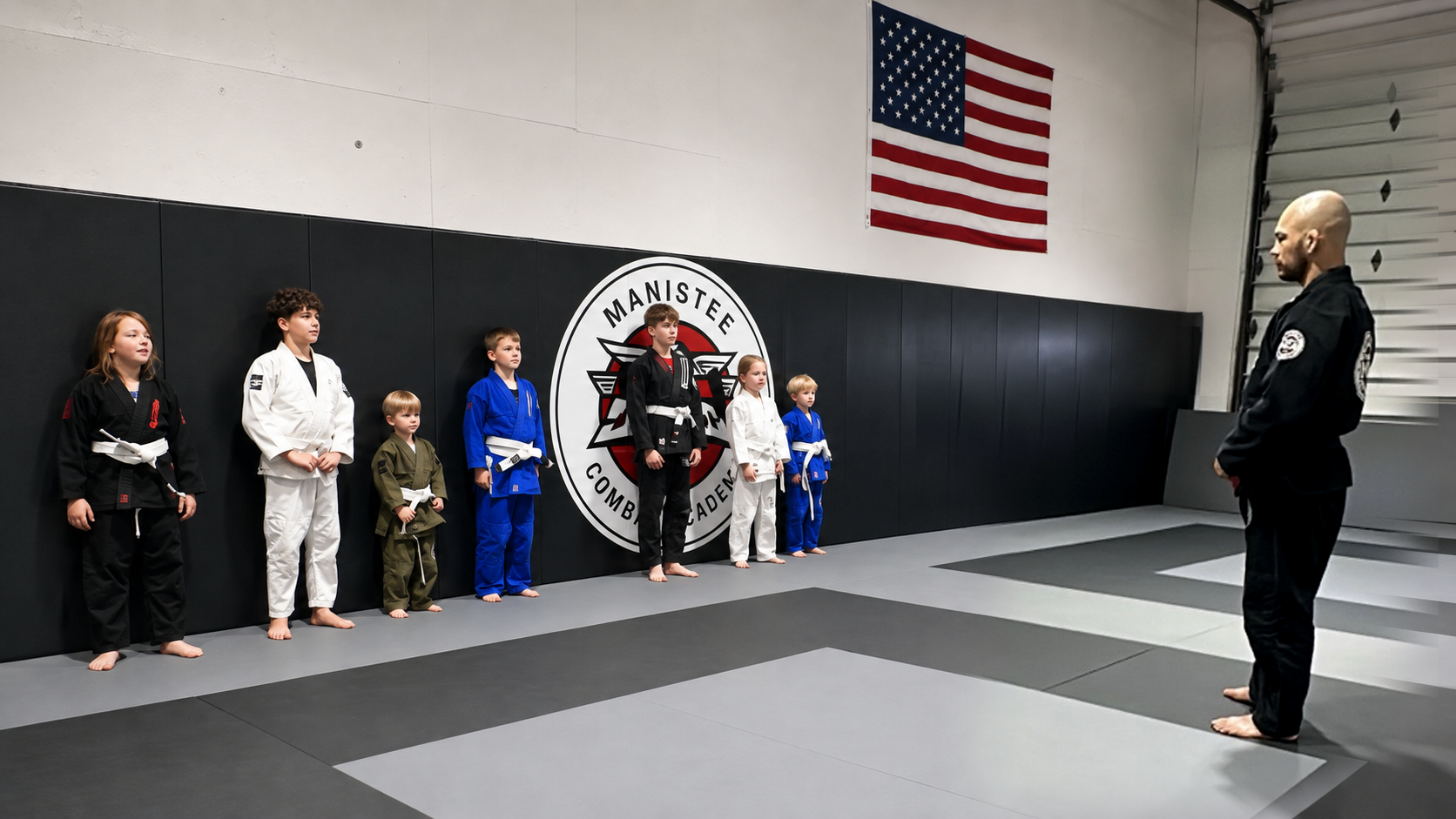 Coach Bren welcoming a young Jiu Jitsu student at Manistee Combat Academy