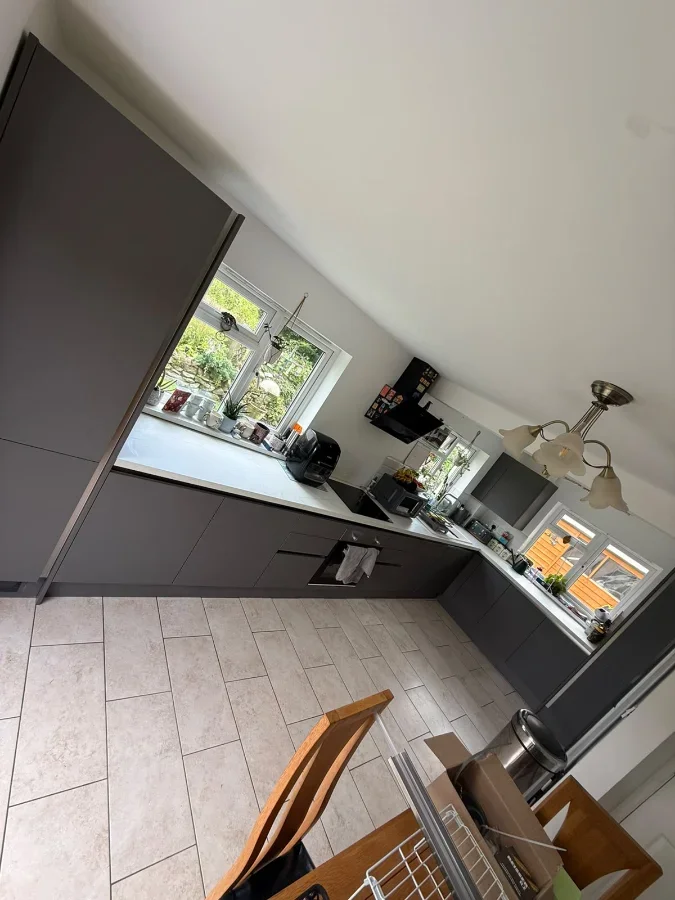 Modern dark grey handle-less kitchen installed during a property refurbishment in Truro 