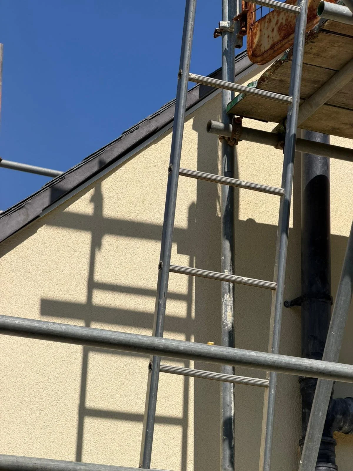 Scaffolded gable end during exterior rendering as part of planned property maintenance