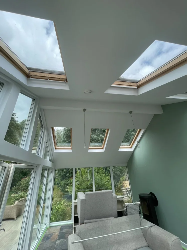 Refurbished garden room in Cornwall with two roof lanterns, Velux windows and a wood burner
