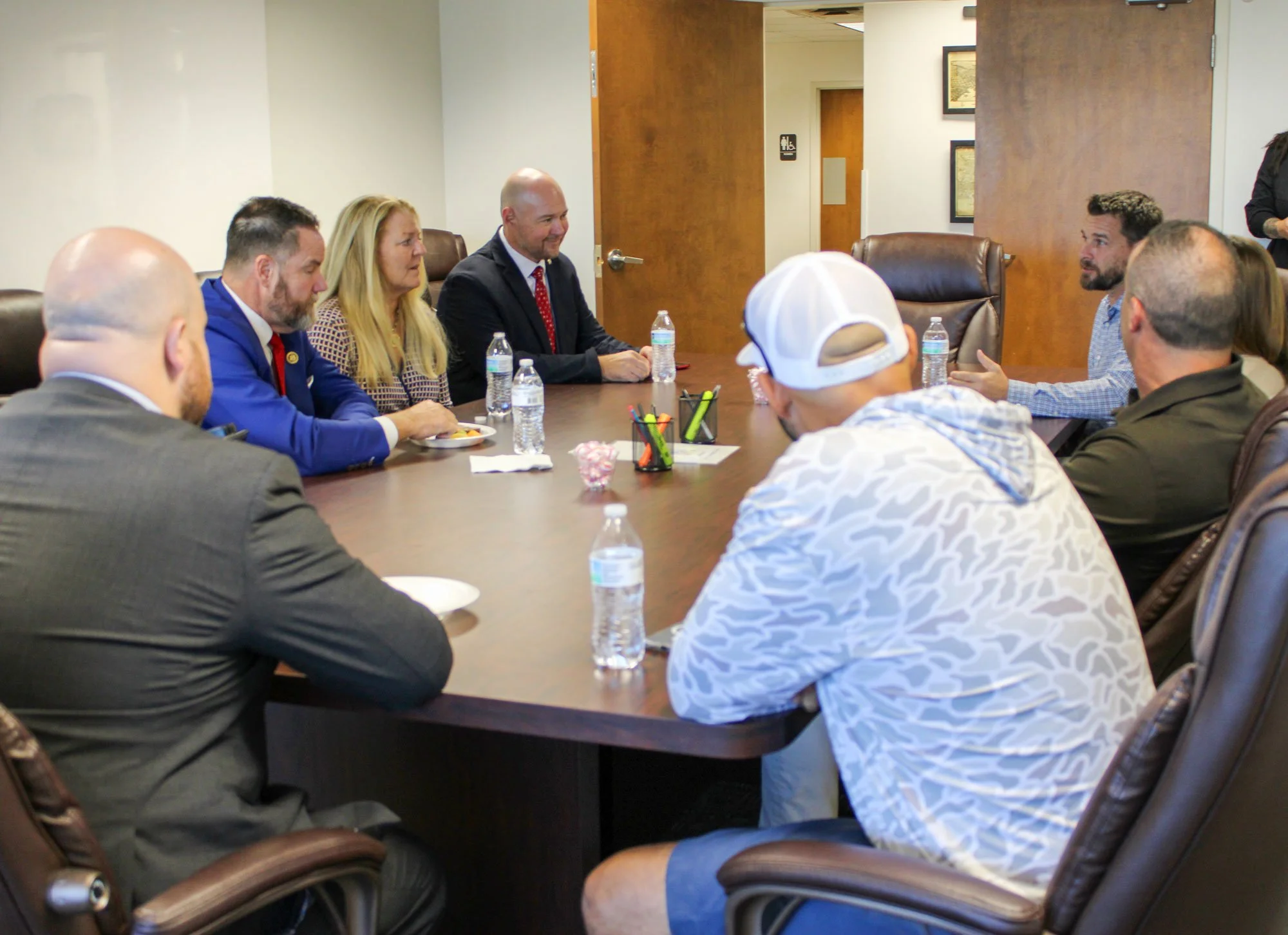 Congressman Aaron Bean, his District Director Bryan Campbell, his Legislative Director Richard LaMura sitting with Woodsman employee-owners.