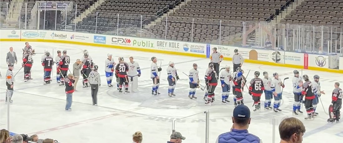 Hockey players from police and fire teams shake hands on the ice after the Guns N’ Hoses game at VyStar Veterans Memorial Arena.