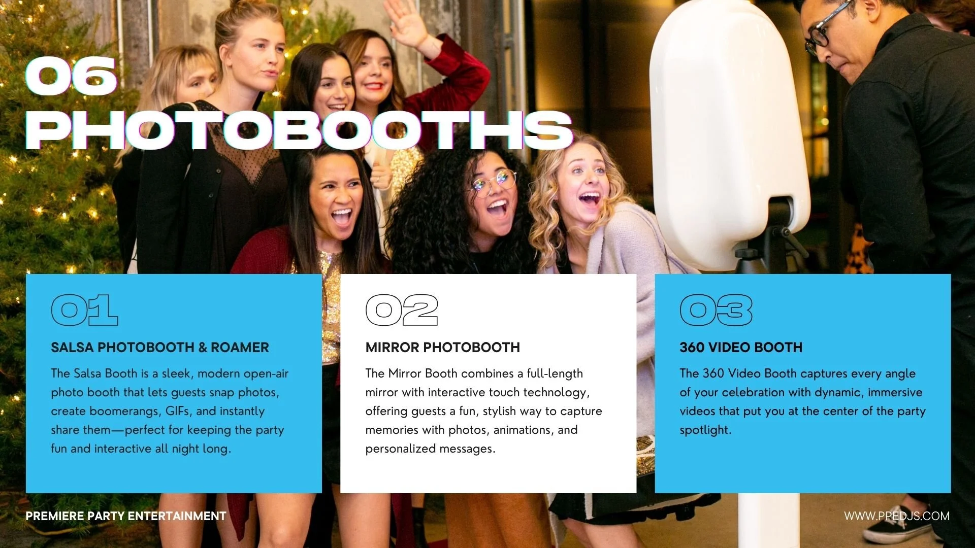 A group of diverse young women smiling and taking photos at a photo booth station during a celebration, with a Christmas tree in the background.