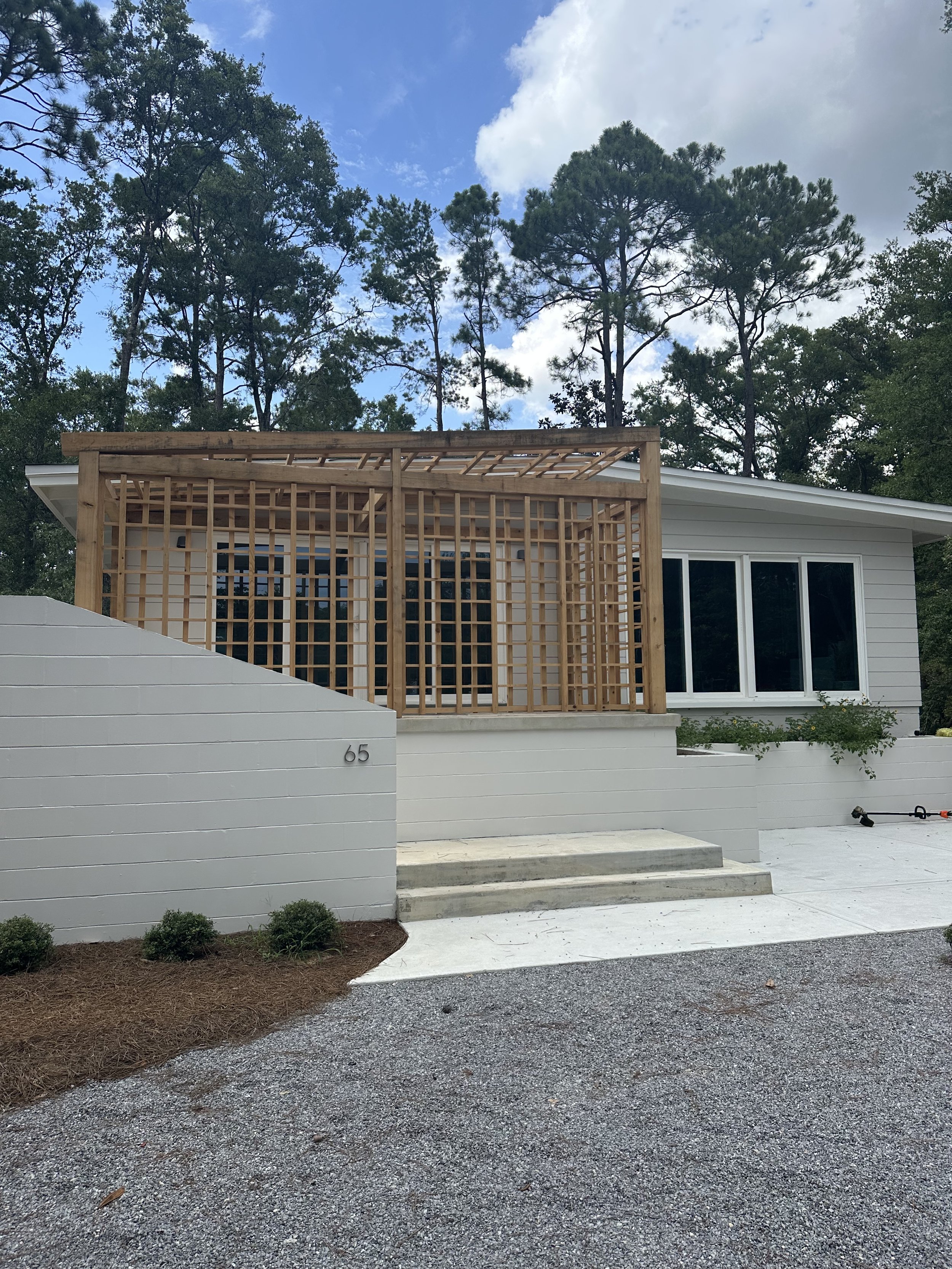 Growing Green families Santa Rosa Beach office is white brick with cypress pergola.