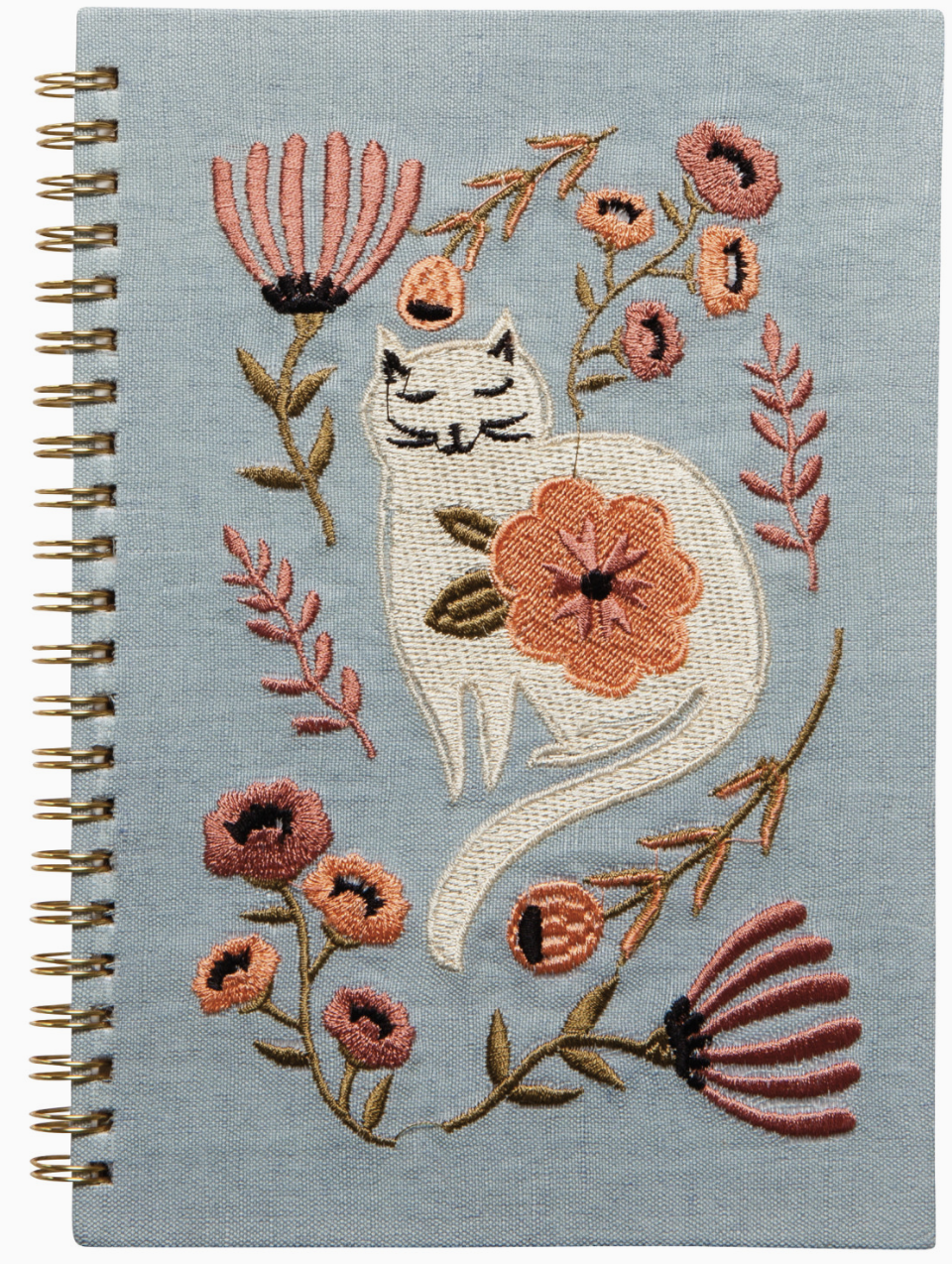 A notebook featuring a cat surrounded by colorful flowers on its cover.