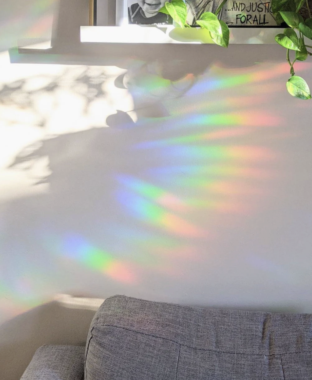 A rainbow-colored light reflection on a smooth white surface creates a vibrant and colorful display.