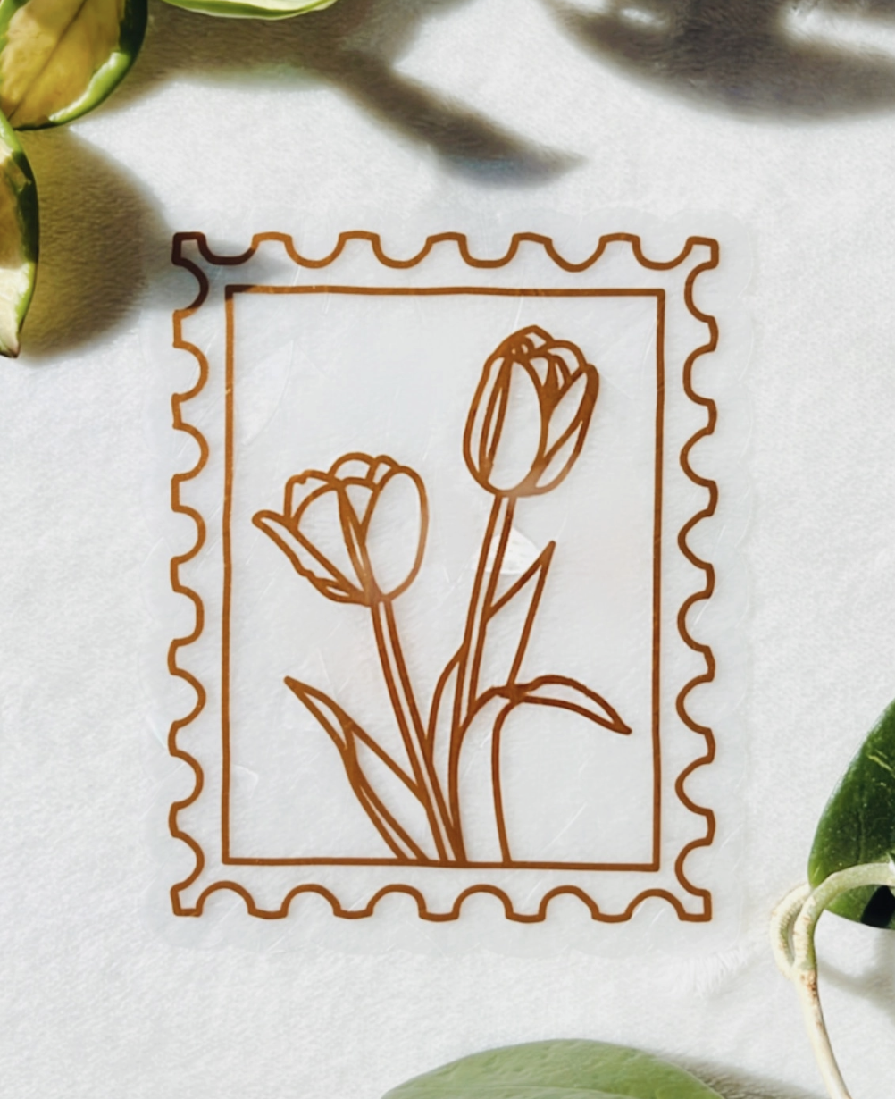A postage stamp featuring a flower design alongside several lemon slices arranged attractively.