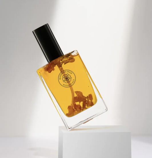 A stylish perfume bottle featuring a leaf as a cap, representing a fusion of fragrance and natural elements.