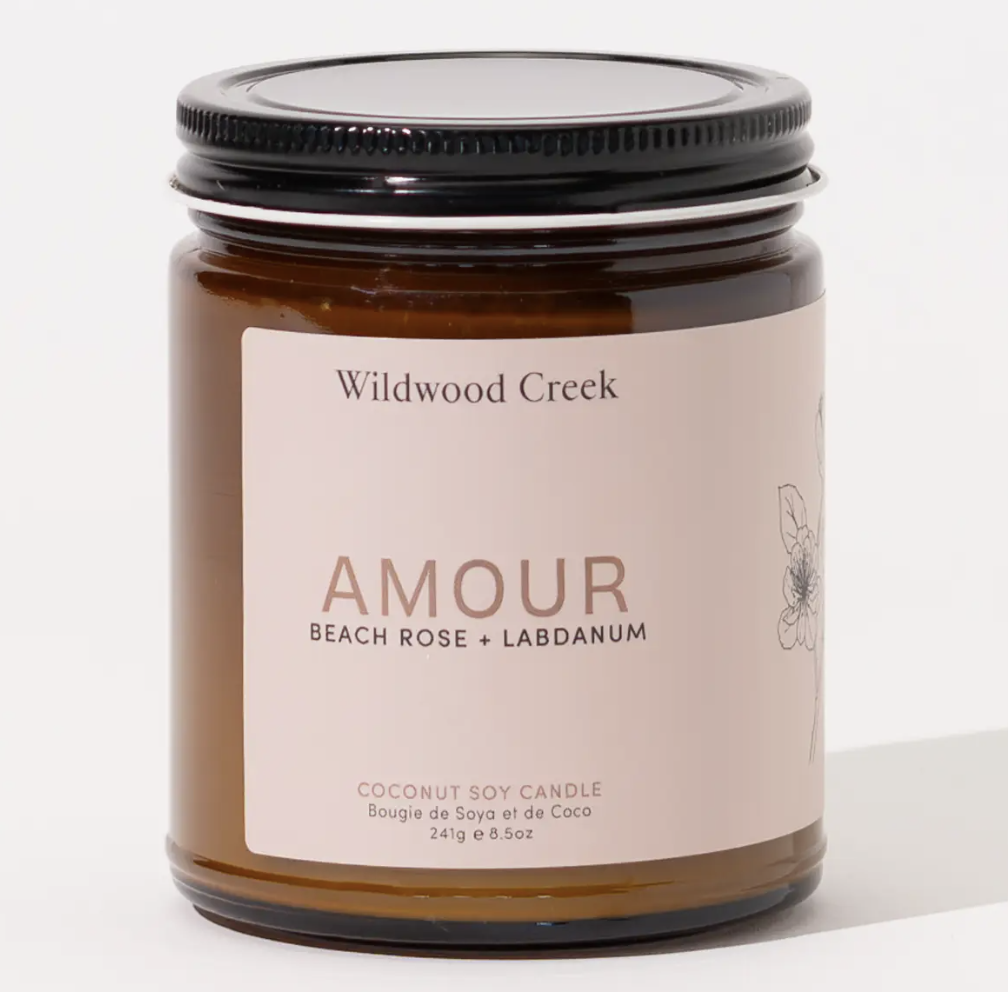 Amour candle from Wildwood Creek, featuring a decorative design and soft glow, ideal for creating a cozy atmosphere.