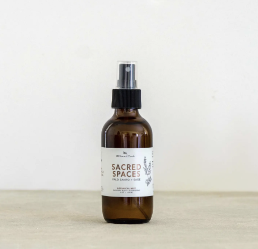 Lavender and peppermint essential oil spray labeled "sacred spaces," featuring a calming design and soothing colors.