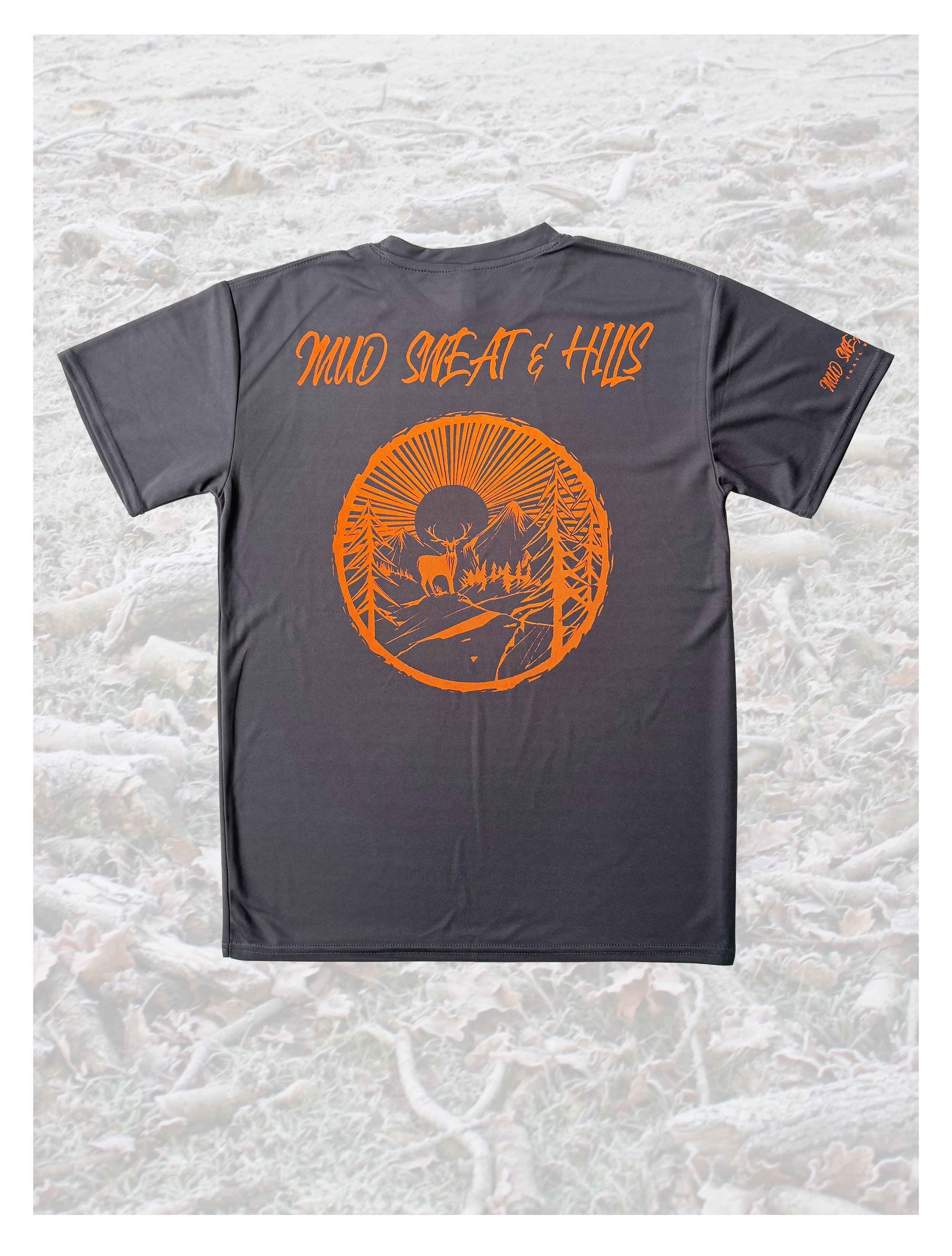 dark grey t-shirt with orange illustration and text lying on a pale background