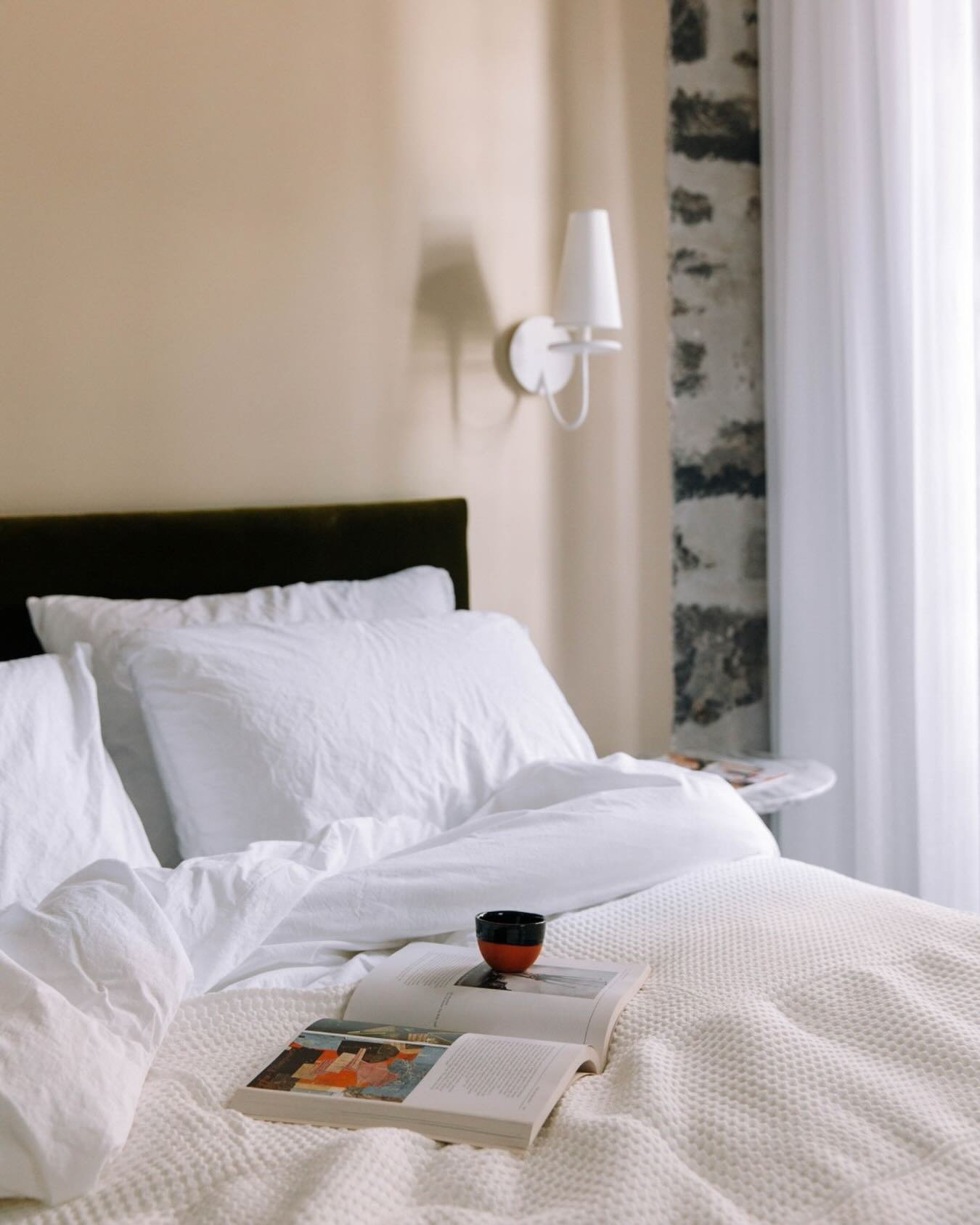 Morning rituals, Montr&eacute;al edition.
Stone walls, soft light, and the quiet luxury of coffee in bed before heading out to explore.