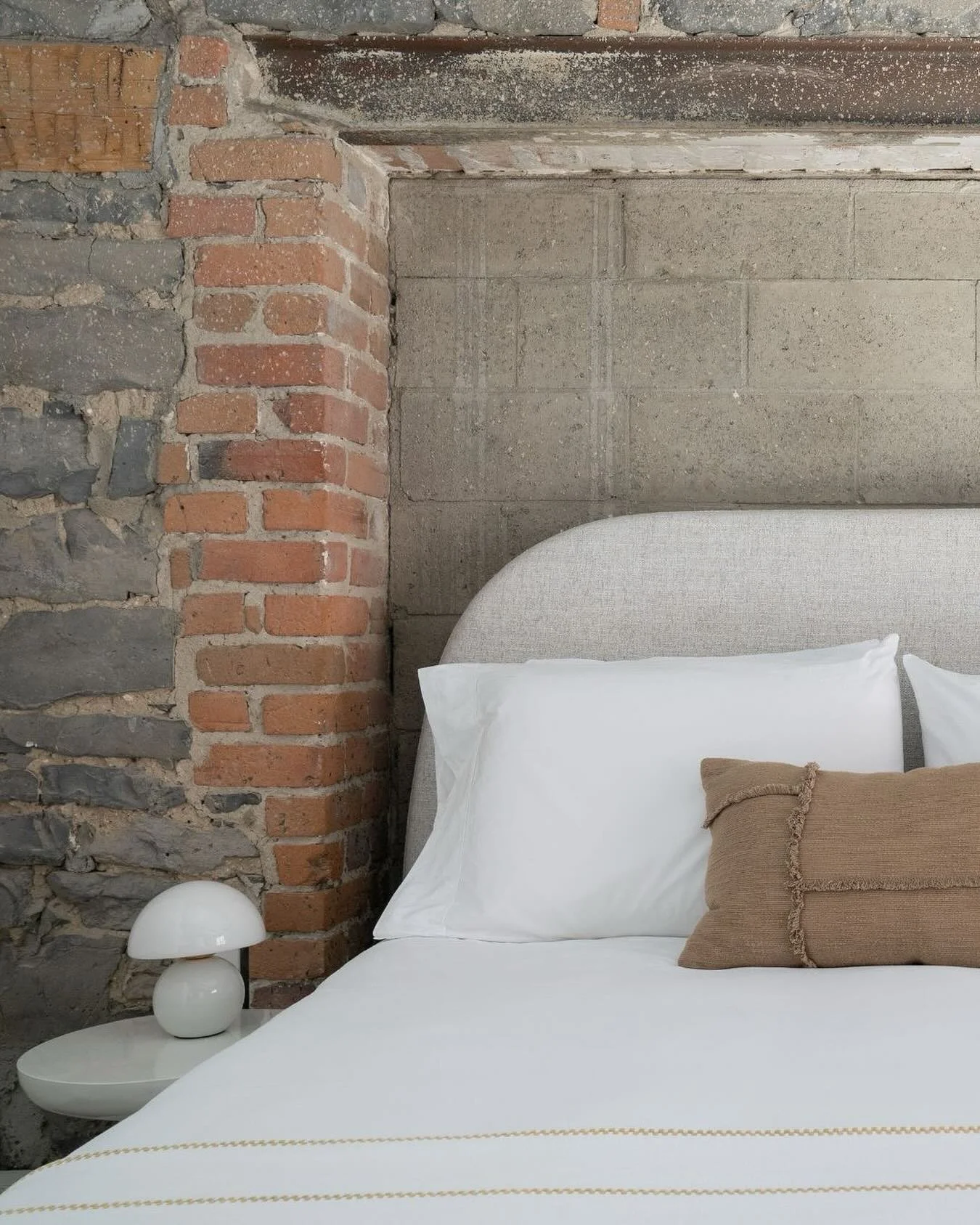 Sleep where history lives. With original stone and brick details, each room reflects the rich heritage of Old Montreal paired with modern comfort.  🗝️ Maison Sainte-Th&eacute;r&egrave;se - Suite 207