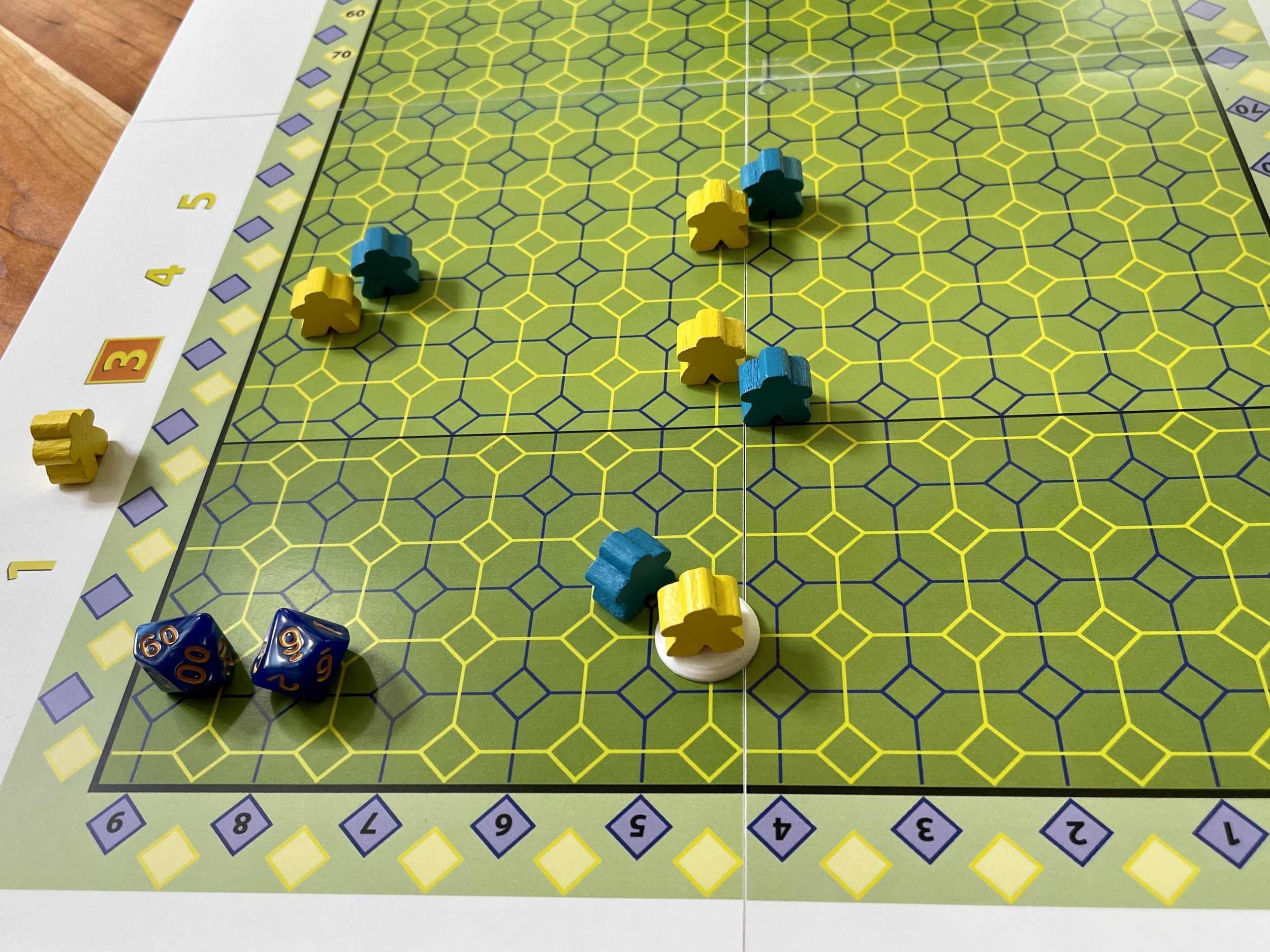 Board game with hexagonal grid, colored tokens, and dice